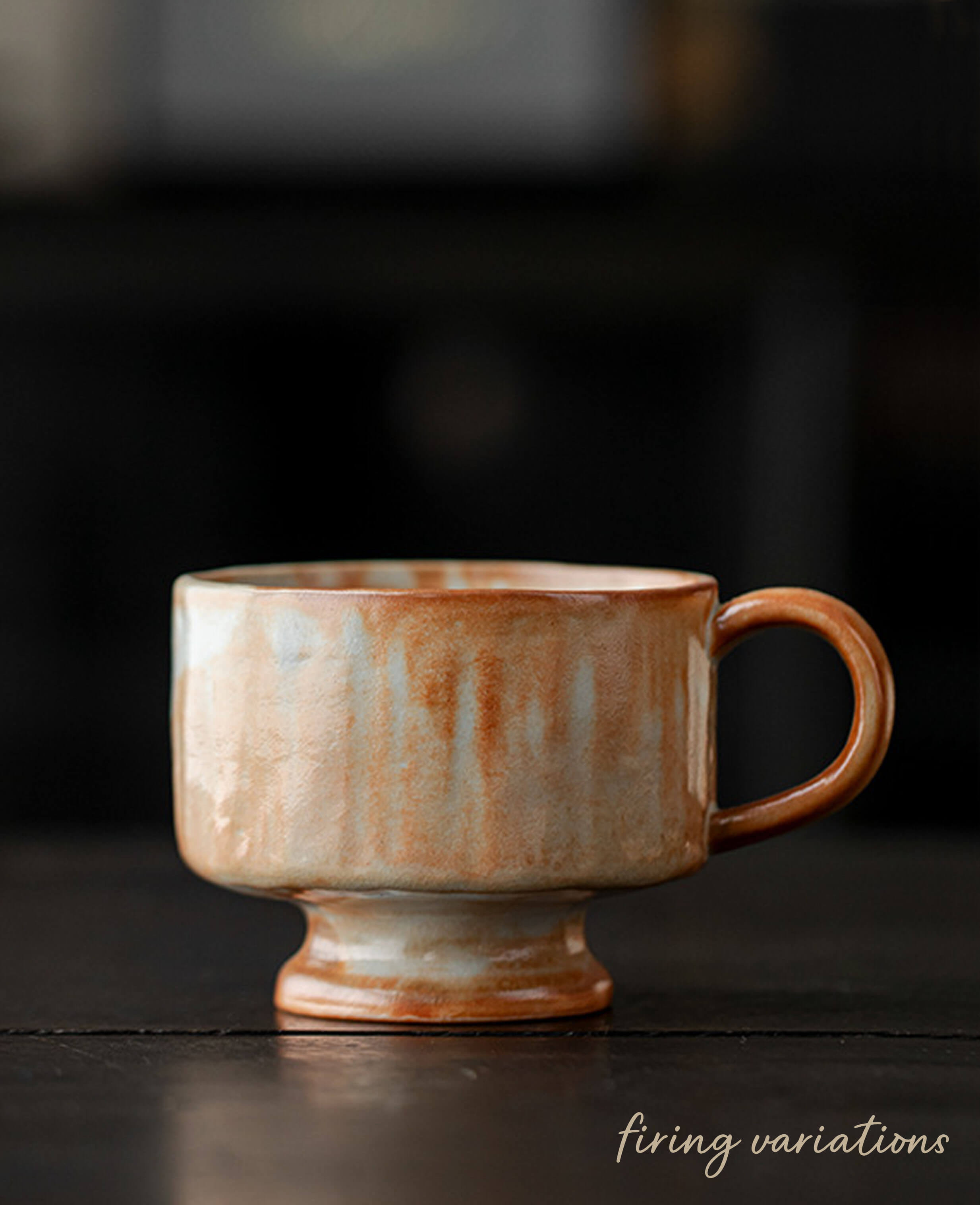 dawn chalice handmade ceramic coffee and tea cup with rustic pedestal foot and warm earthy tones and smooth curved handle