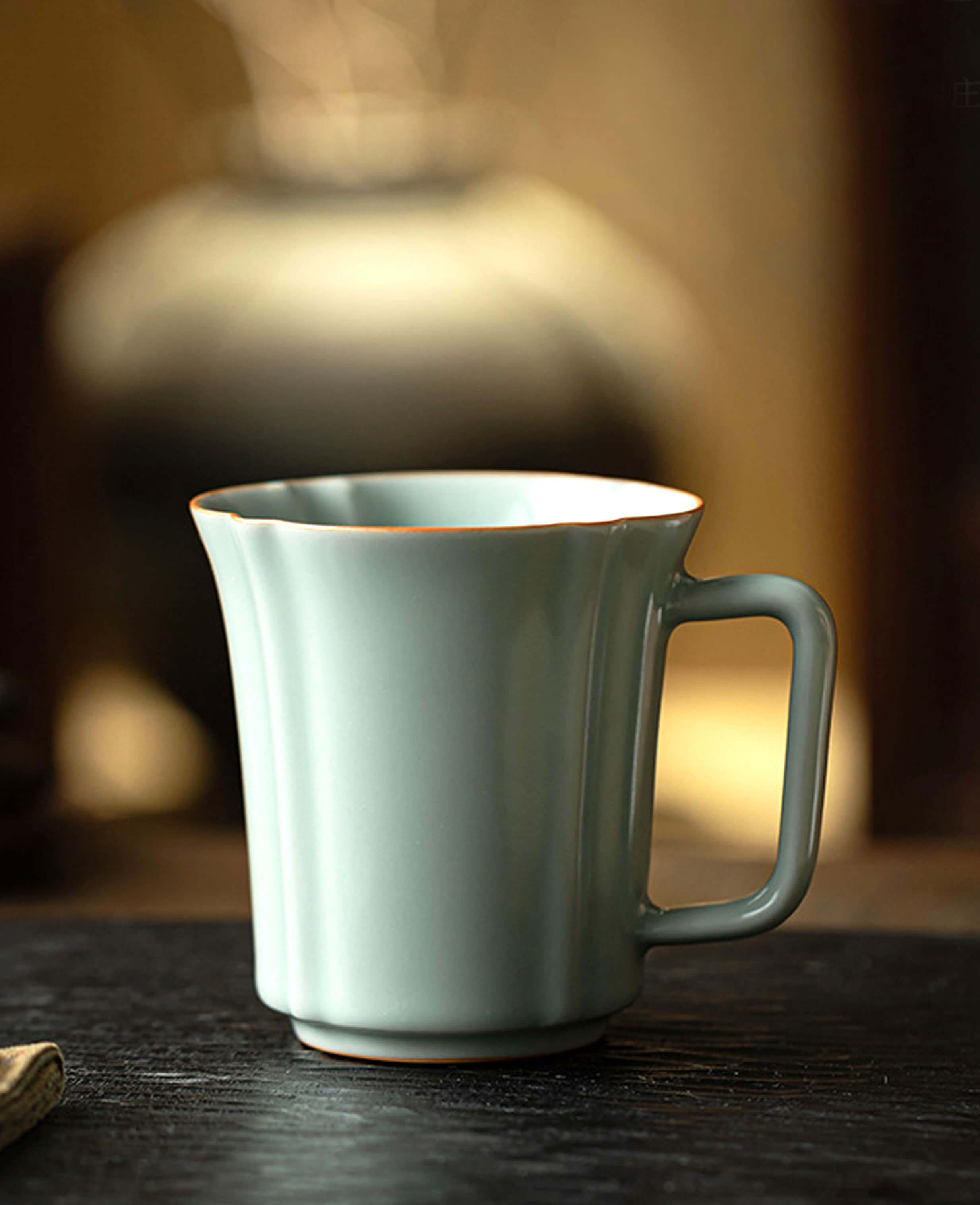 side profile of echo of ru porcelain mug showing artisan form and handle shape