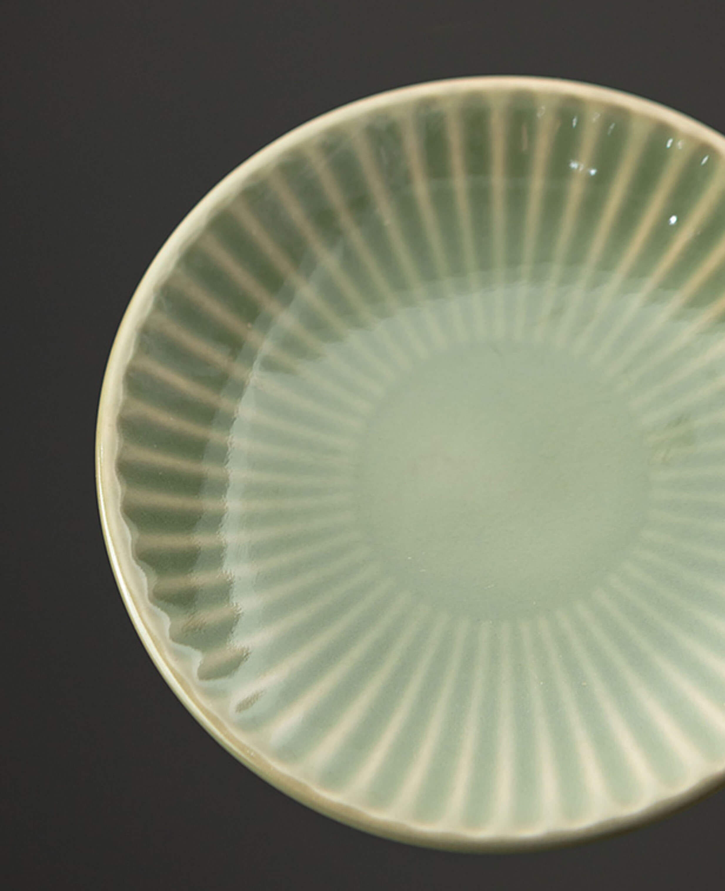greenstill whisper porcelain saucer with fluded green glaze close up top view