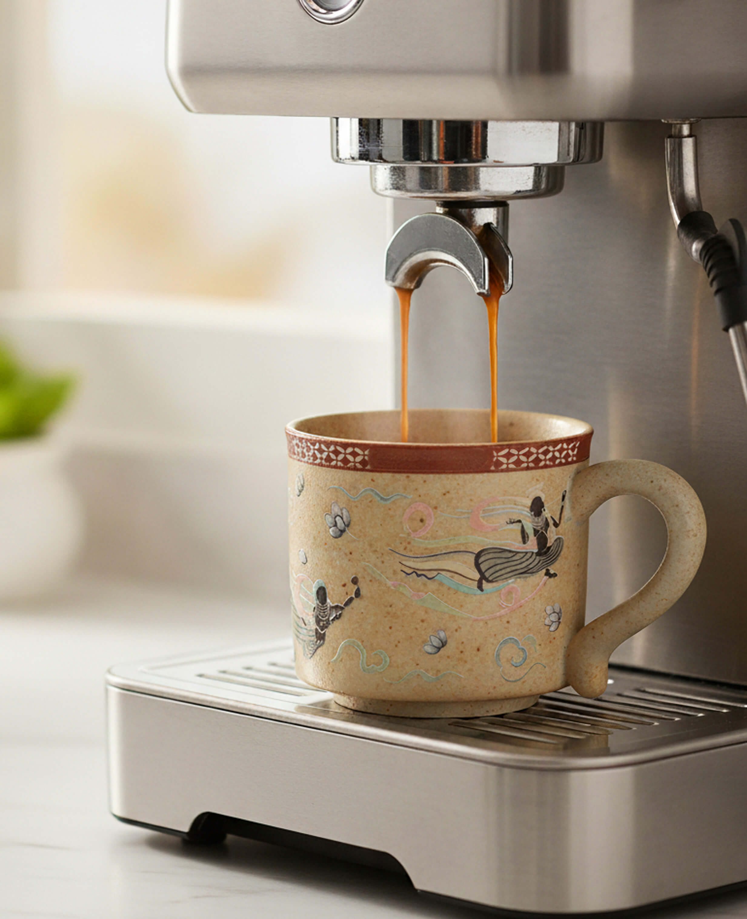 handcrafted ceramic cup with flying apsaras design inspired by dunhuang art under coffee machine