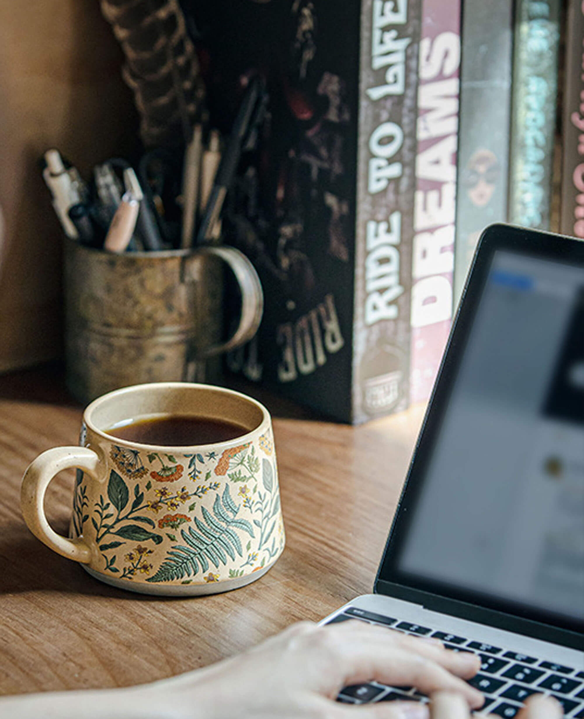 july note ceramic stoneware coffee mug beside a laptop on a desk in use during work from home coffee break