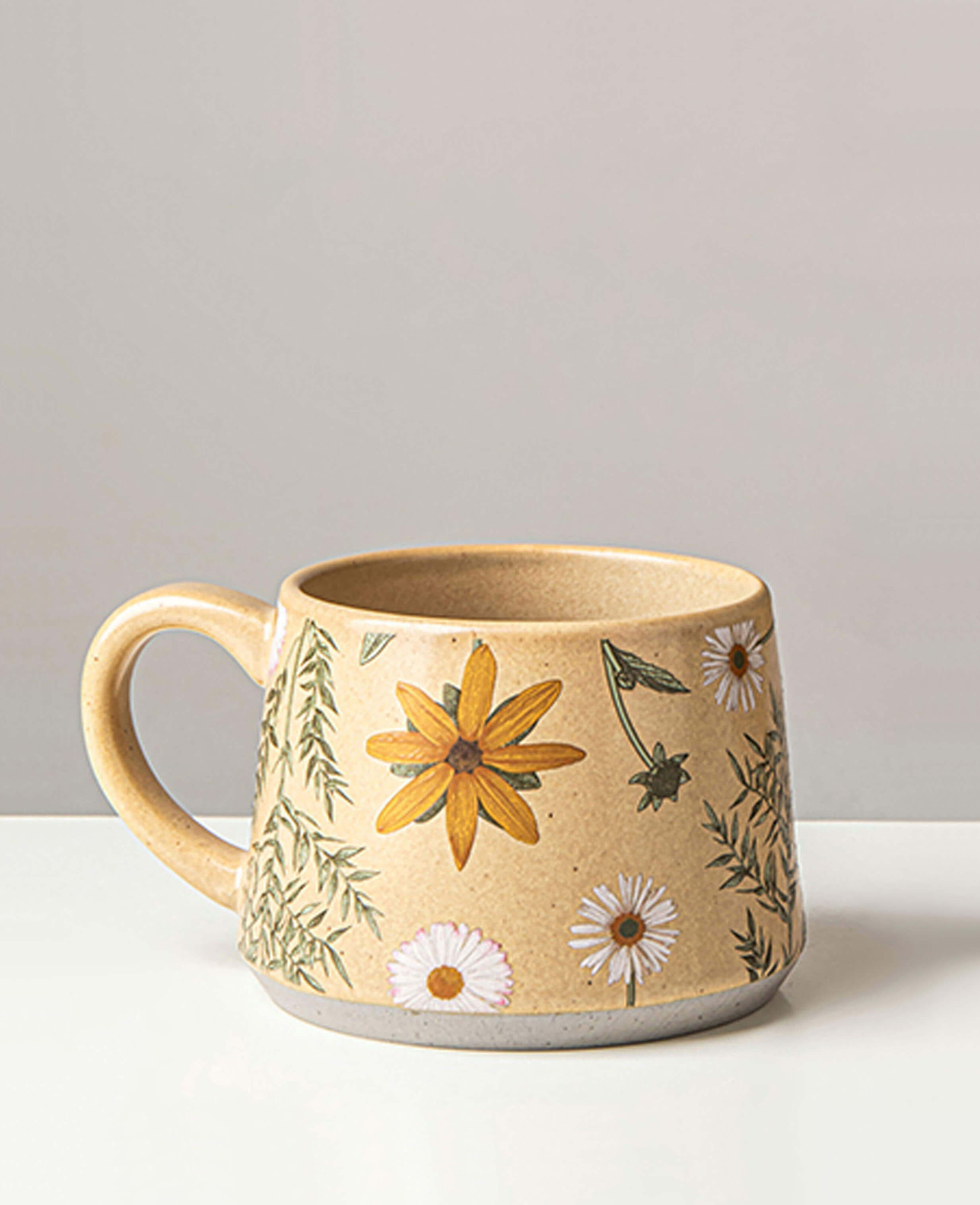 june whisper handcrafted ceramic coffee and tea mug with yellow black eyed susan and daisy prints on white backdrop