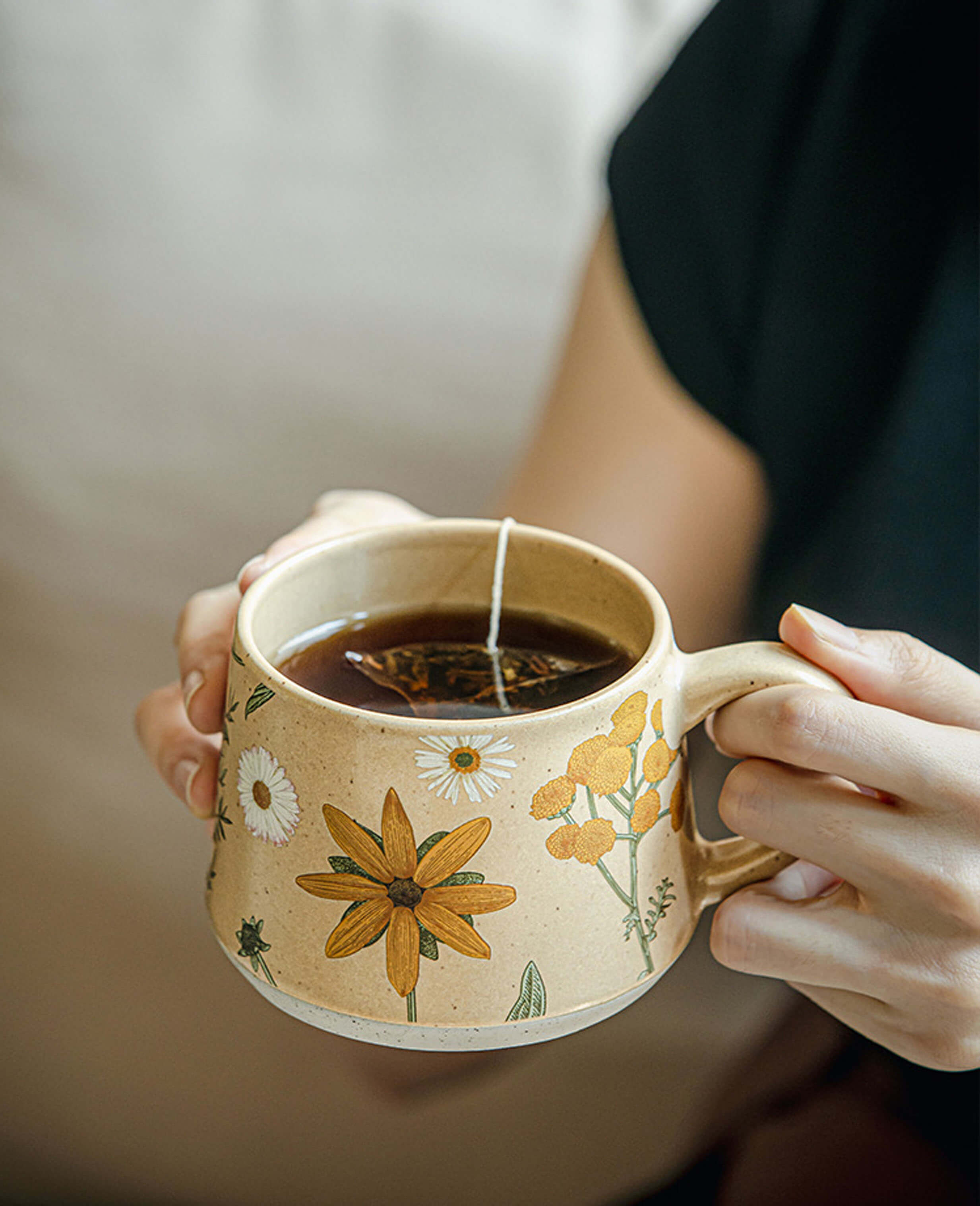 handcrafted june whisper ceramic tea mug with herbal infusion daisy and yellow flower design summer drinkware