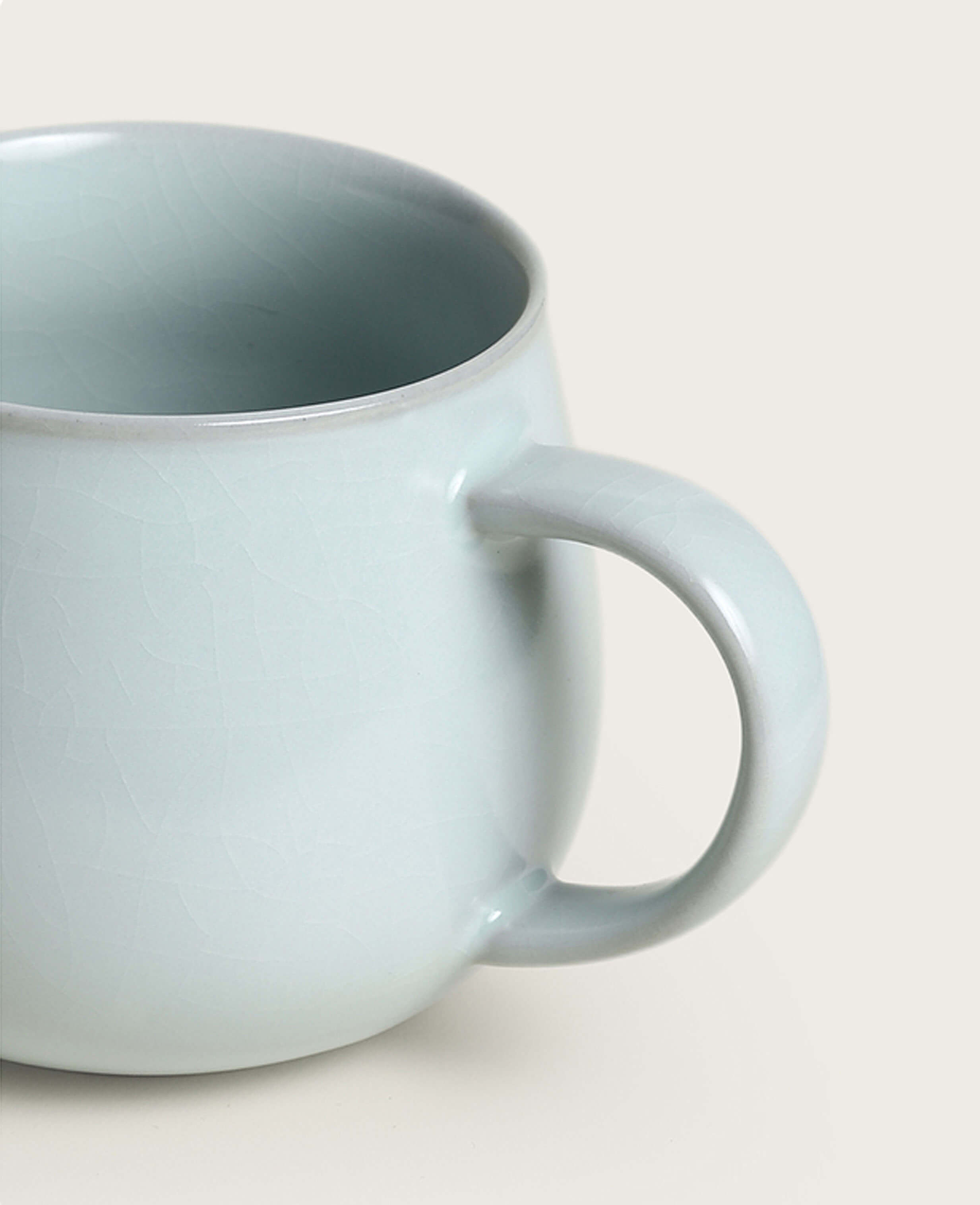 side close up of handle and smooth celadon surface on luna gleam porcelain ru ware mug