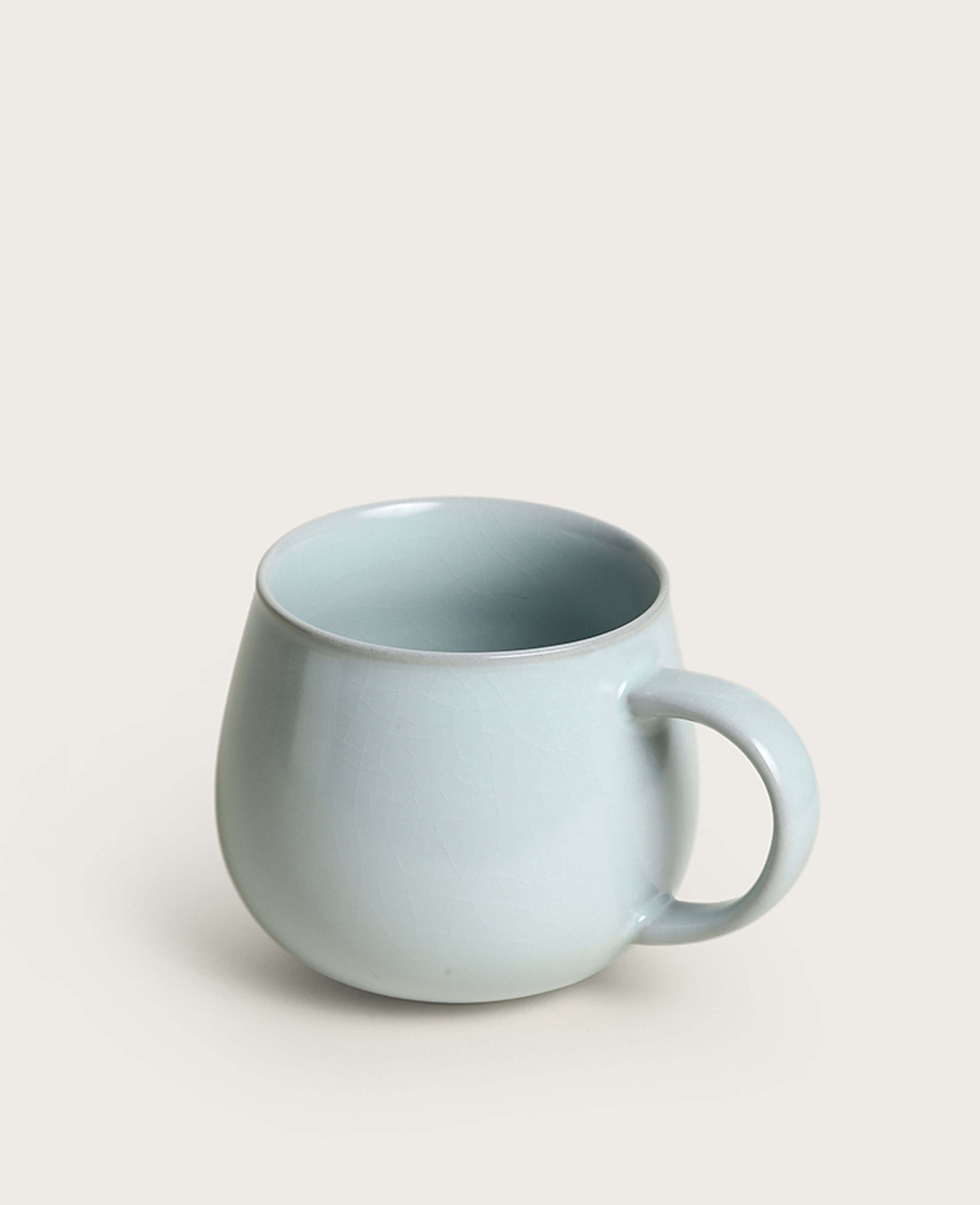 side profile of soft celadon ru ware porcelain mug with gentle rounded shape