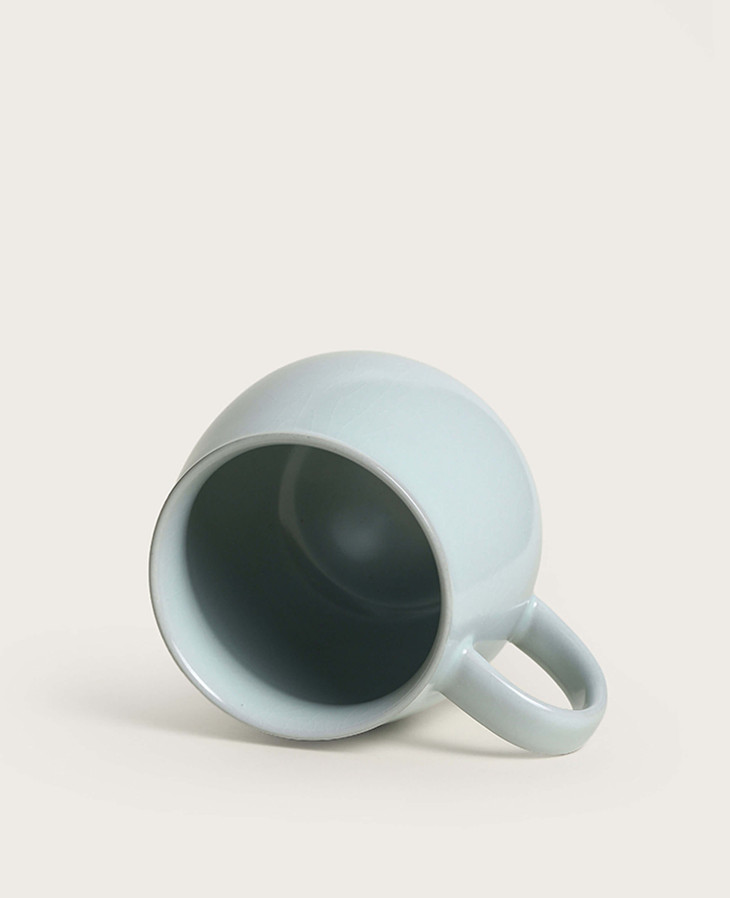 top view of ru style celadon coffee mug placed on its side
