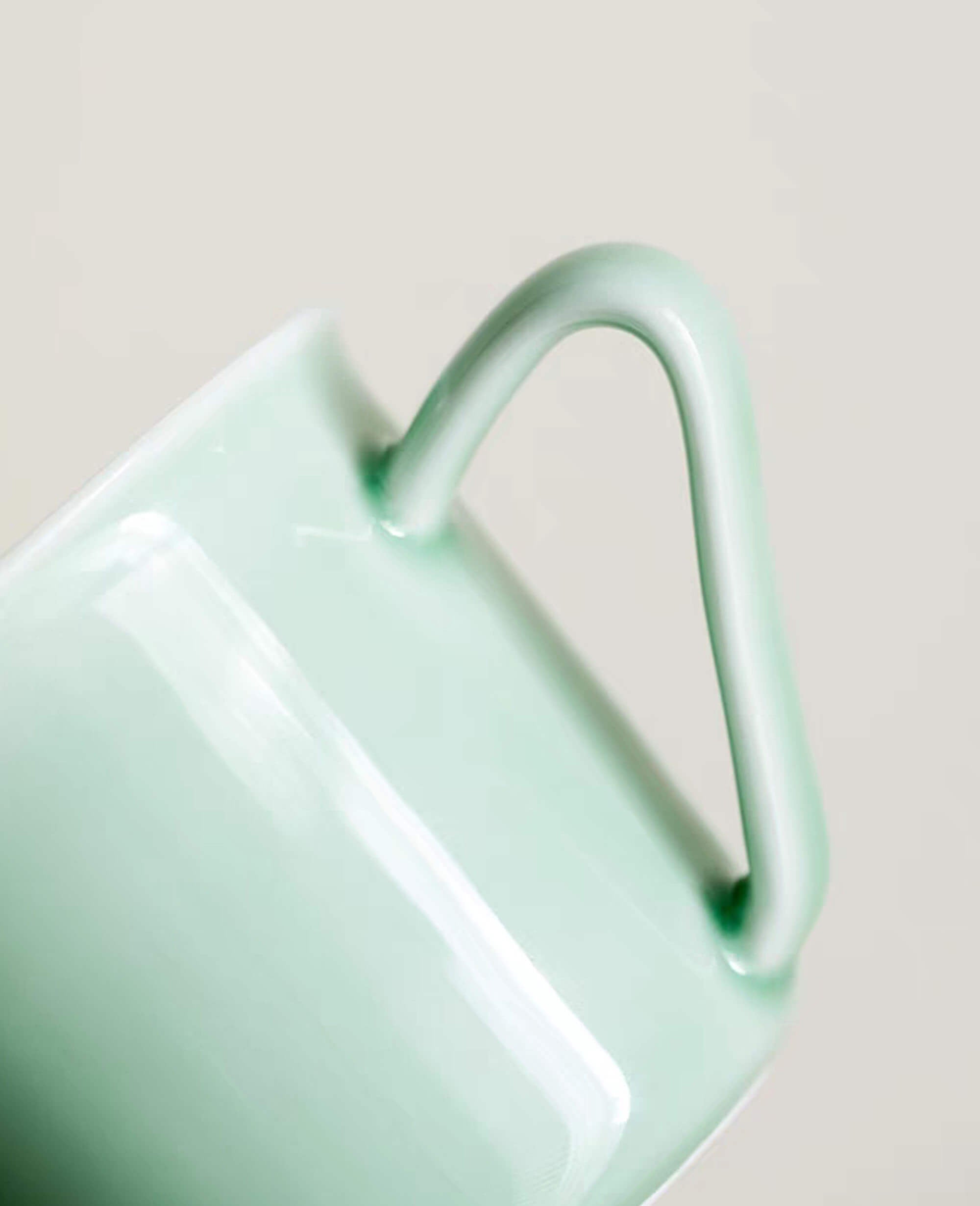 closeup of mint green porcelain cup handle from the minted memory painted diary collection