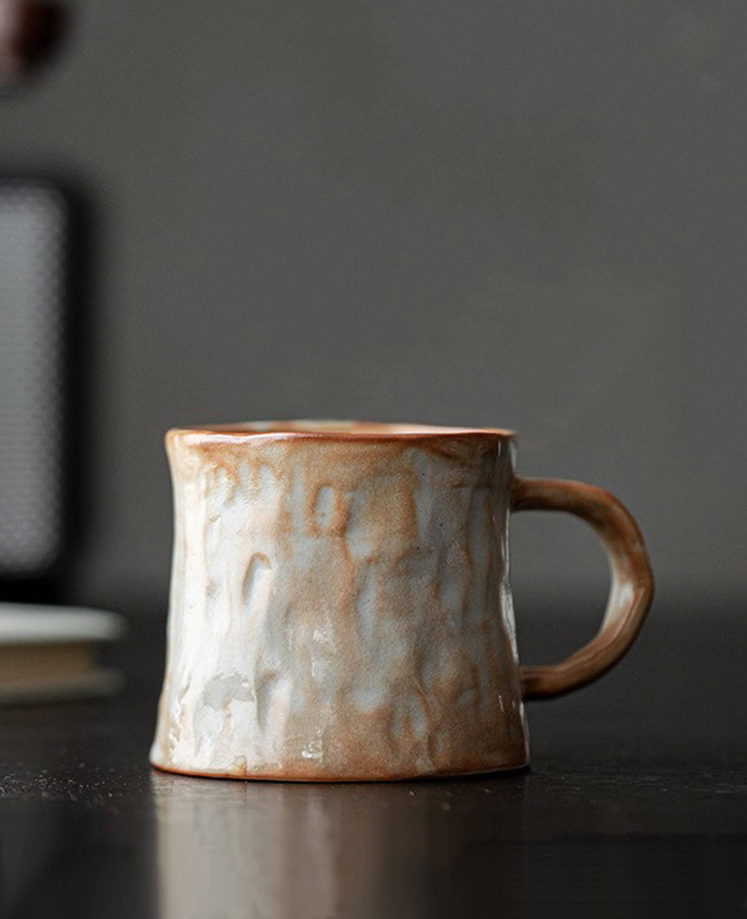mistburn handcrafted ceramic coffee and tea mug with wood fired glaze in warm terracotta and grey mist tones