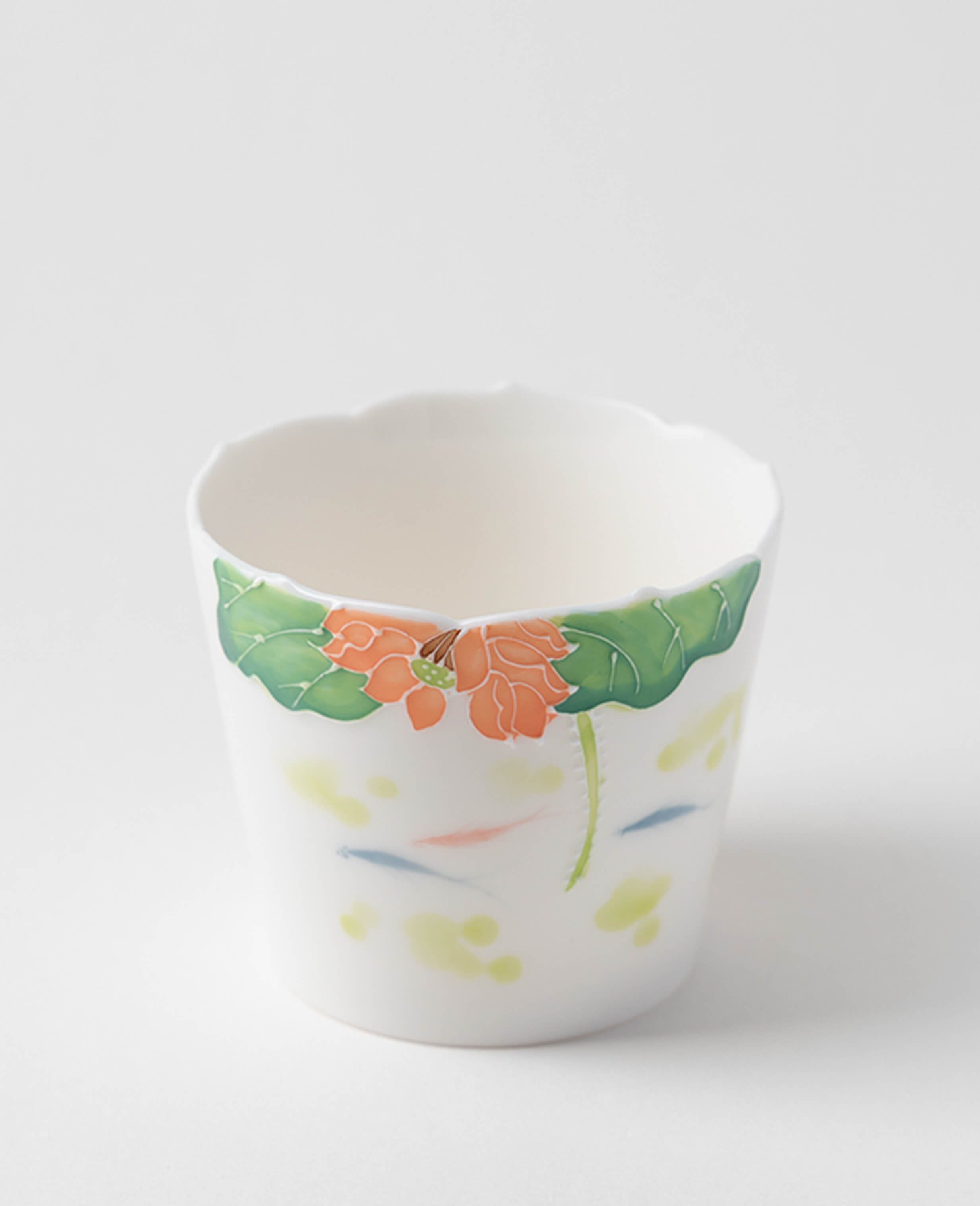 handcrafted porcelain coffee and tea cup featuring lotus flower and leaf design captured from the front view
