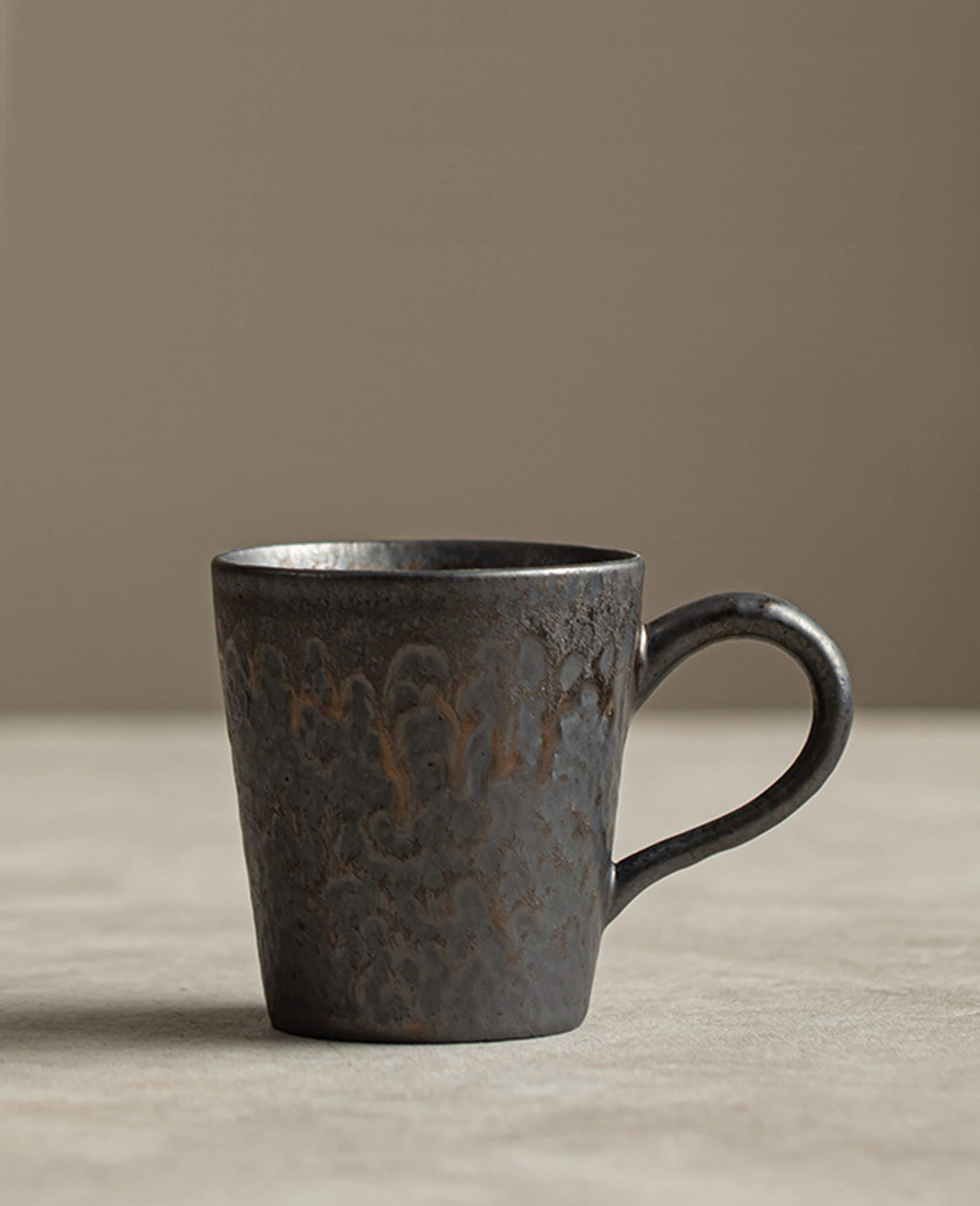 rustglow cove handcrafted rustic coffee mug upright on fabric surface
