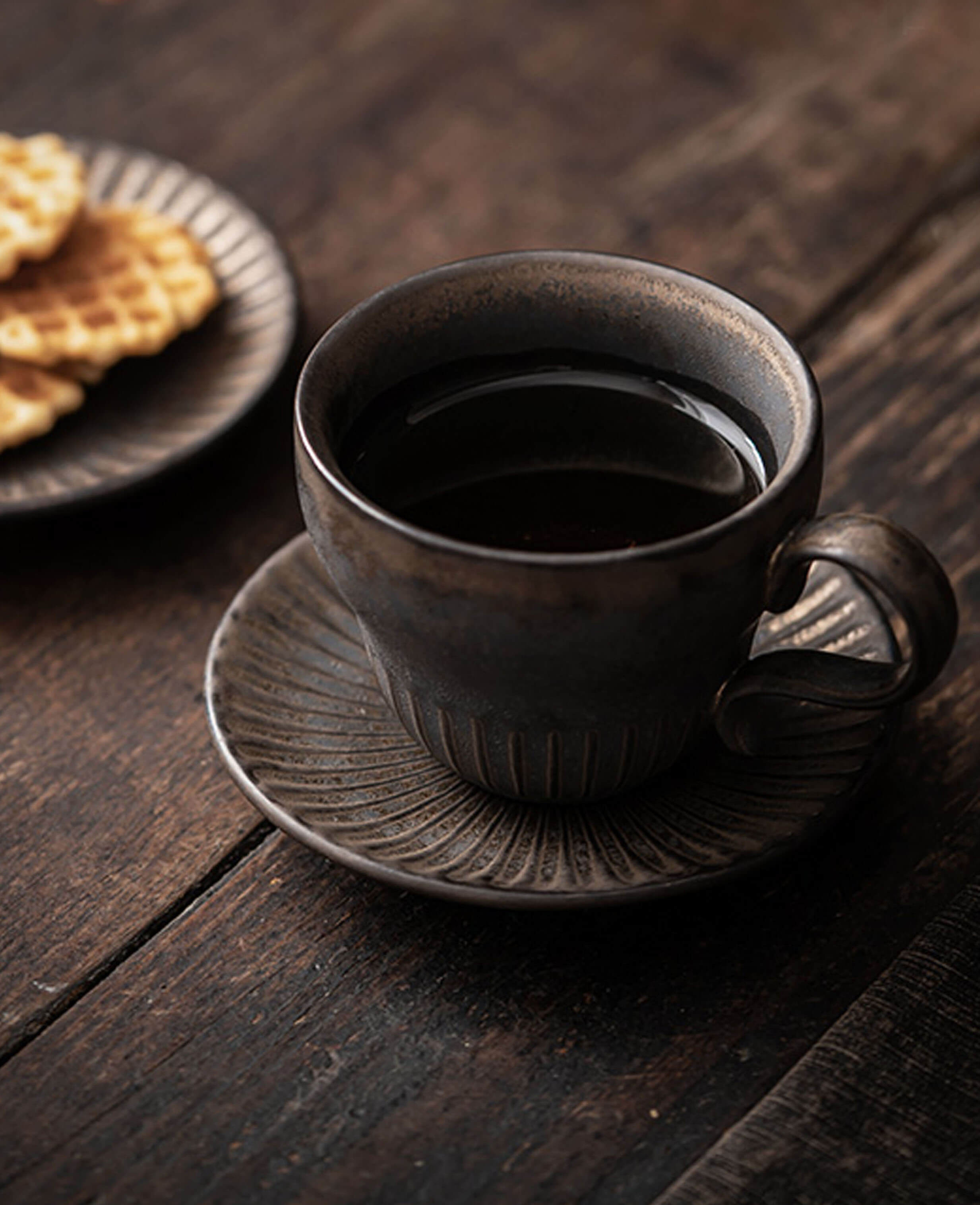 rustglow crest filled rustic coffee cup and saucer on table