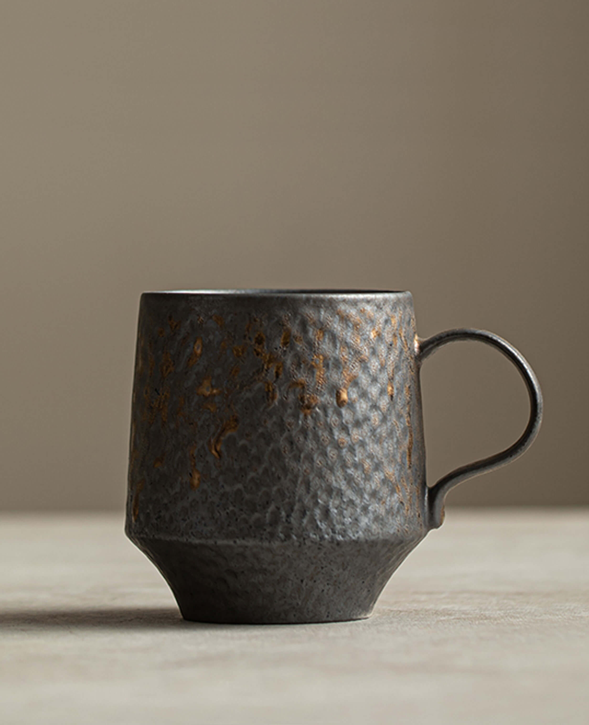 front view of the rustglow obel ceramic coffee mug with its distinctive flared pedestal base