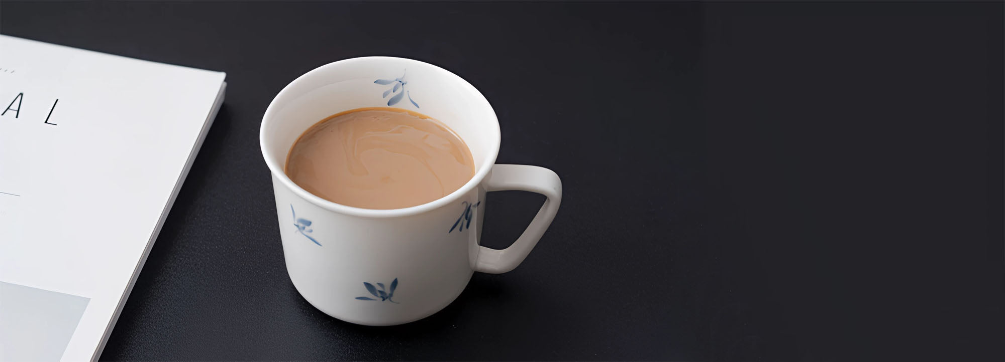 serene drift hand painted floral coffee and tea cup on black table with magazine from painted diary collection