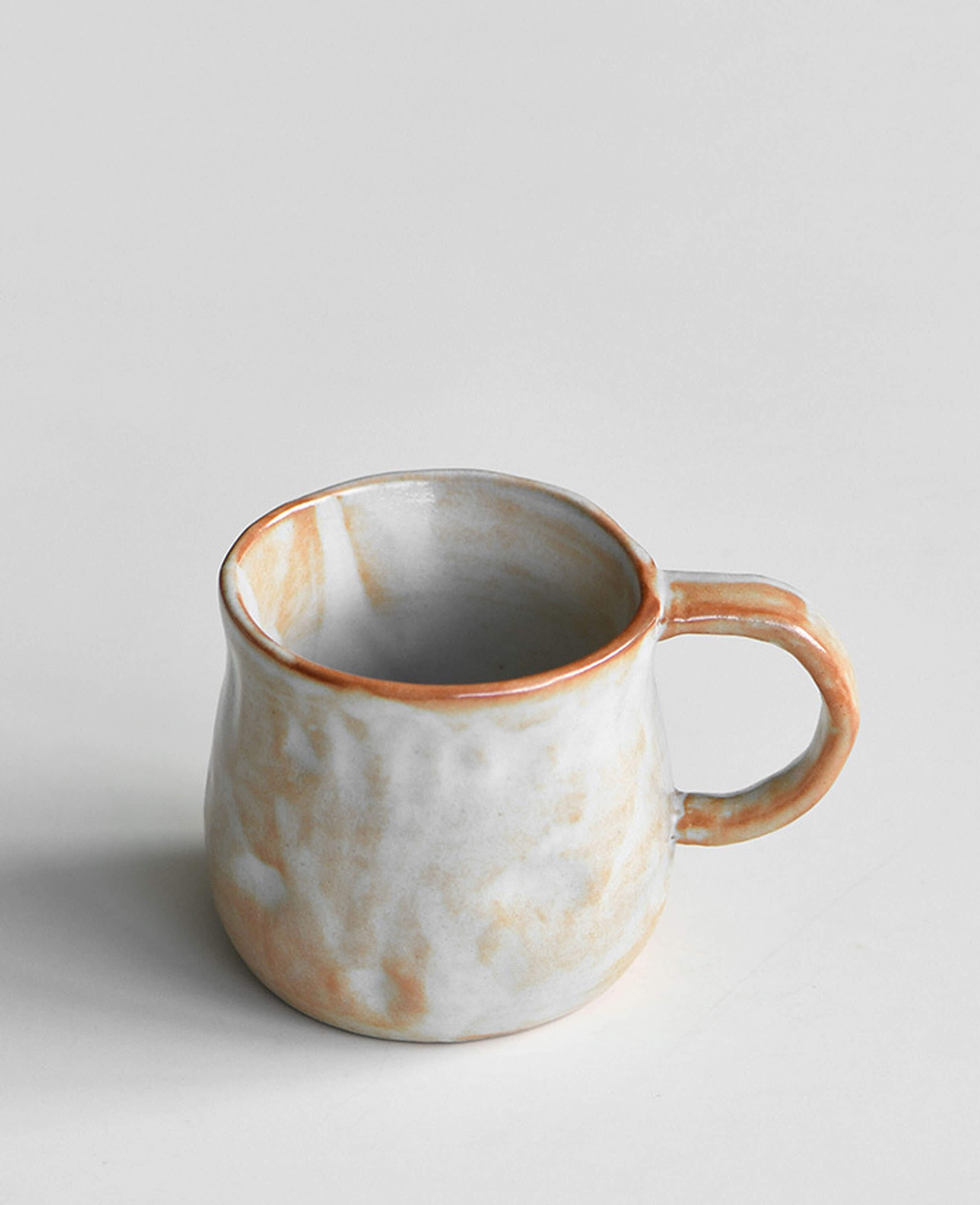 handmade stoneware coffee and tea cup front profile snowcrest wood fired flame glaze with warm ochre highlights