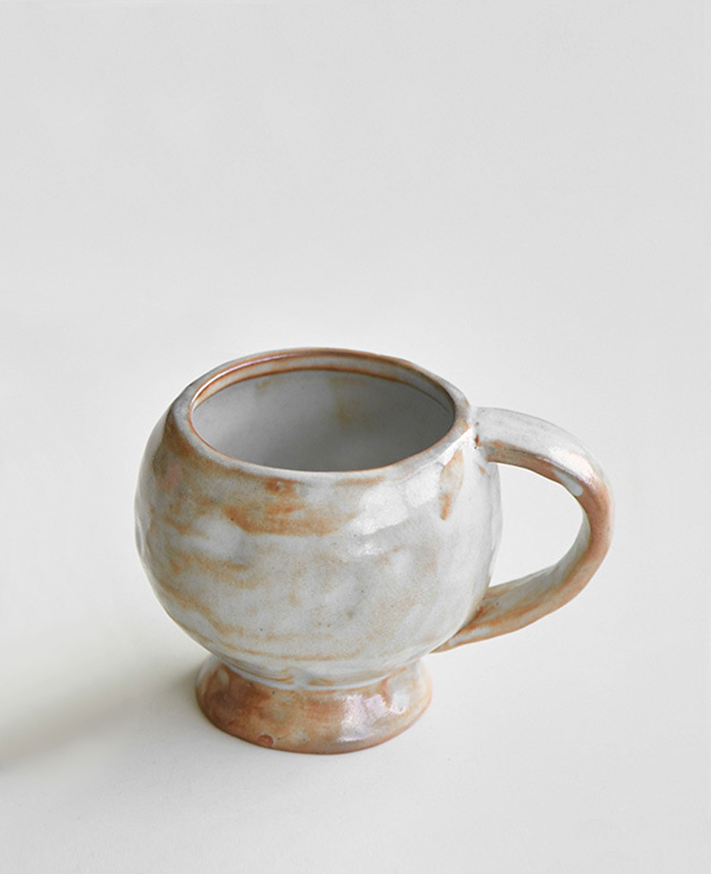 solterra handcrafted ceramic coffee and tea cup with elegant footed design in earthy white glaze