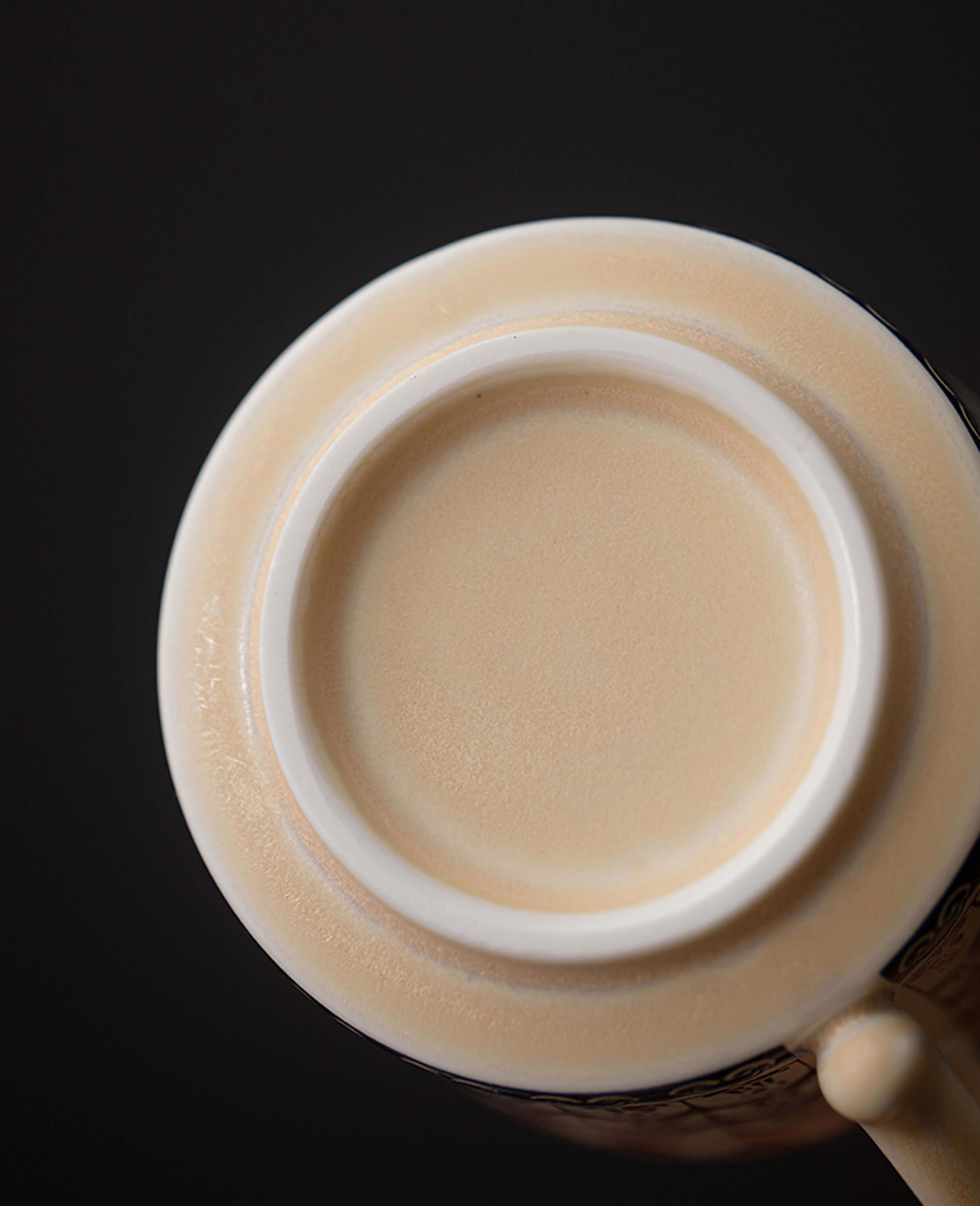 base view of handcrafted ceramic tea cup showing unglazed bottom with soft matte texture
