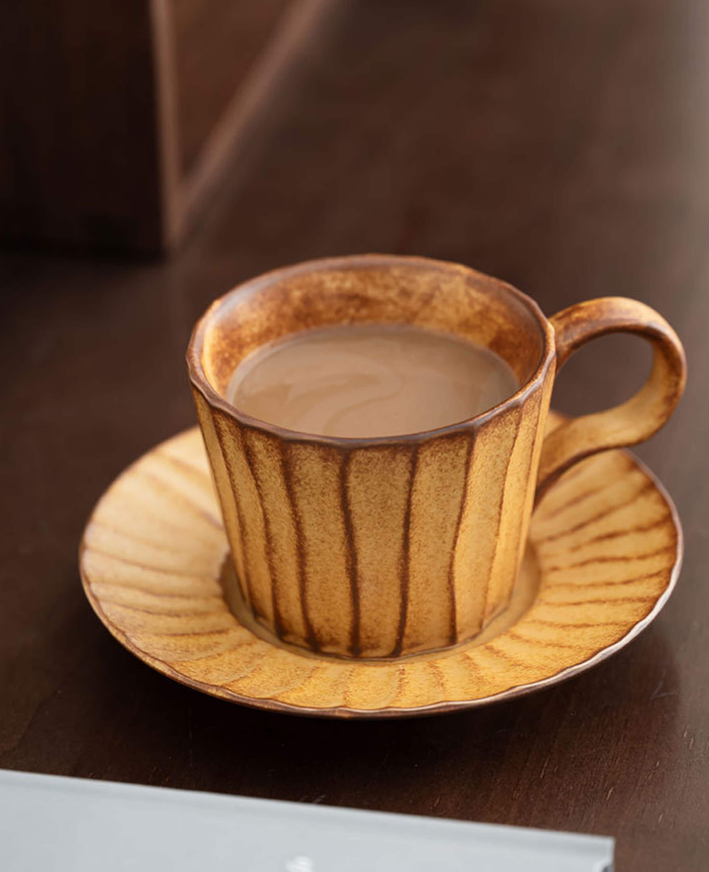 toffee reverie flow ceramic coffee cup filled with coffee on dark wood surface