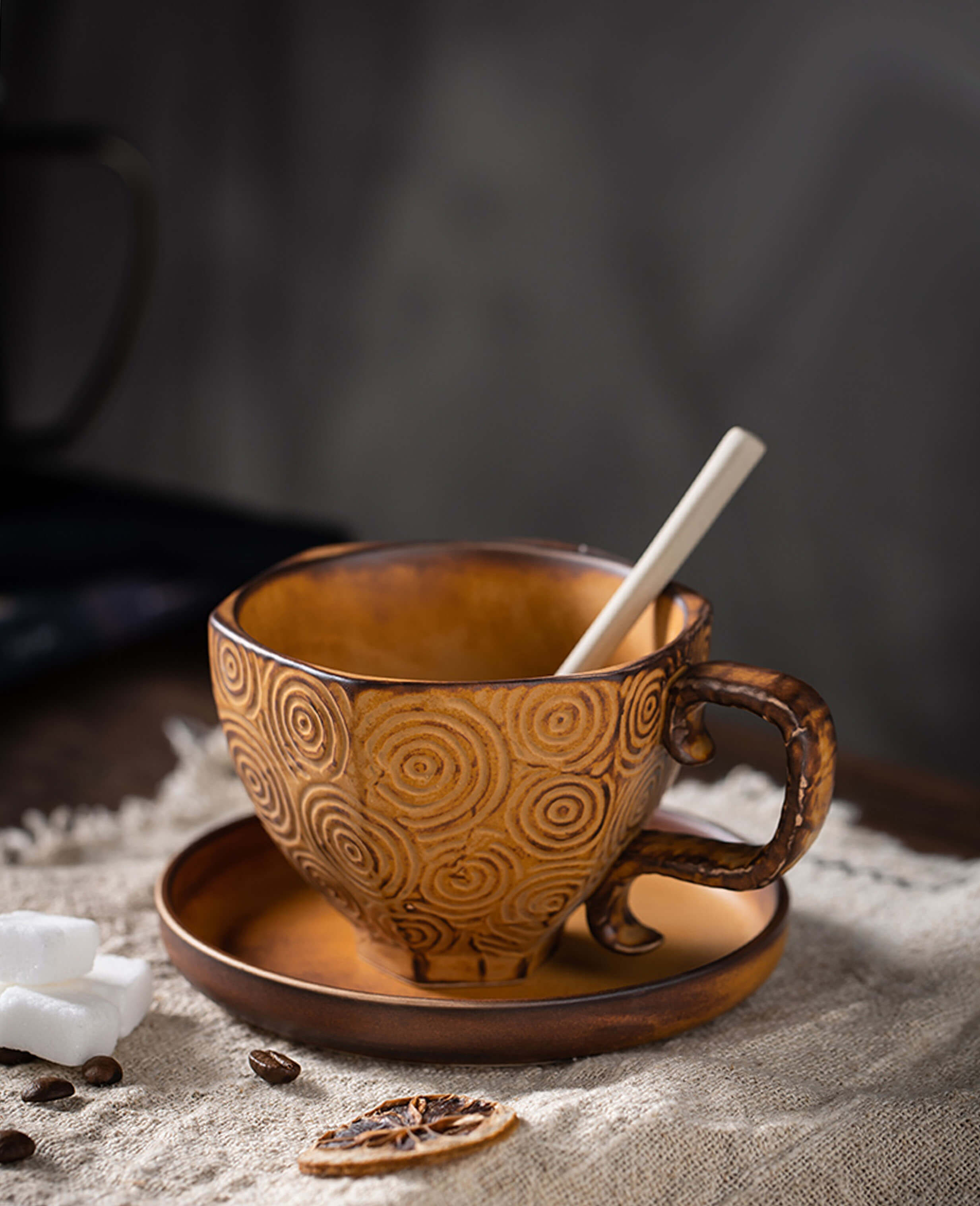 toffee reverie mirage closeup of empty stoneware coffee cup with spoon