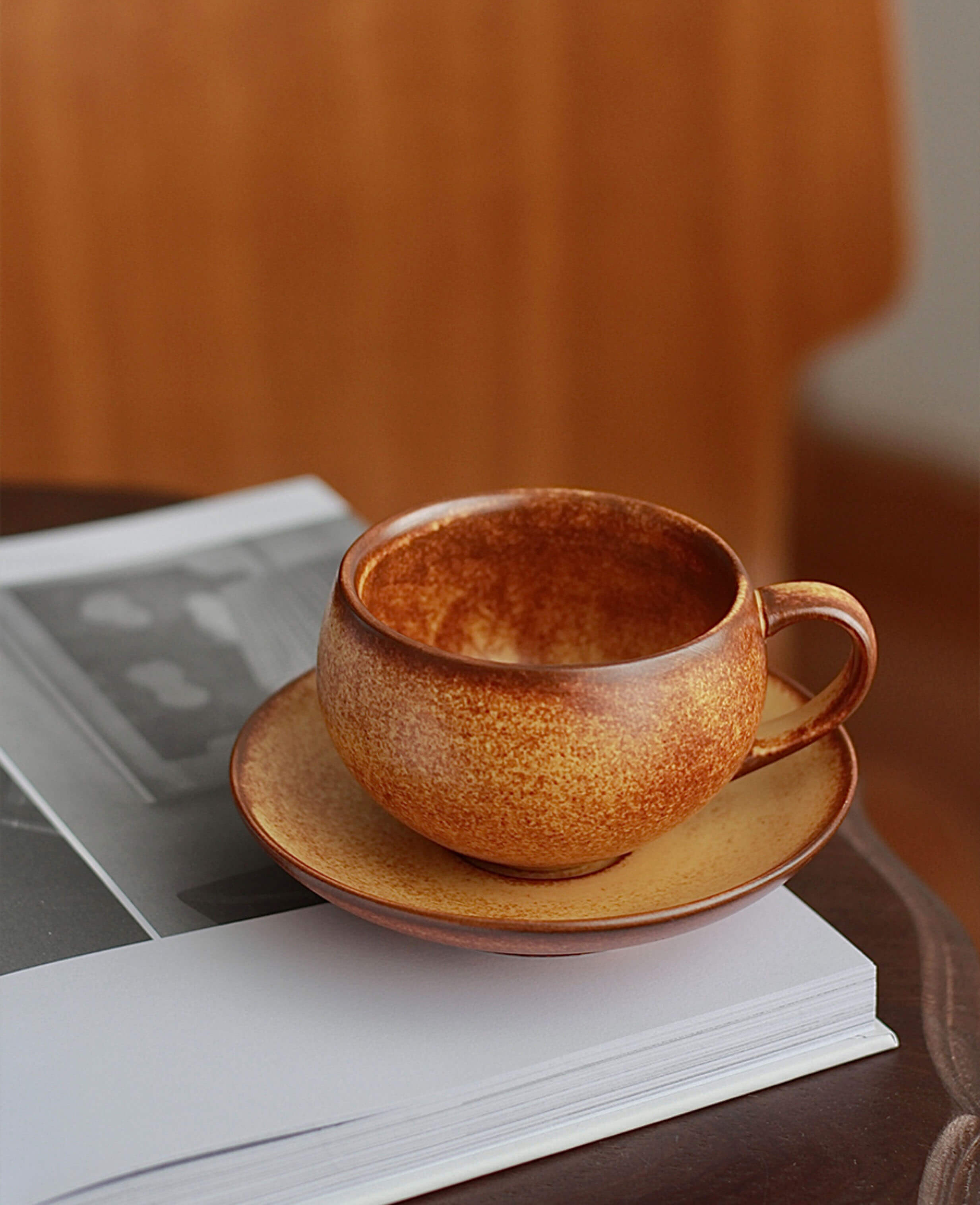 toffee reverie ovolo ceramic cup and saucer styled on wooden table with natural light