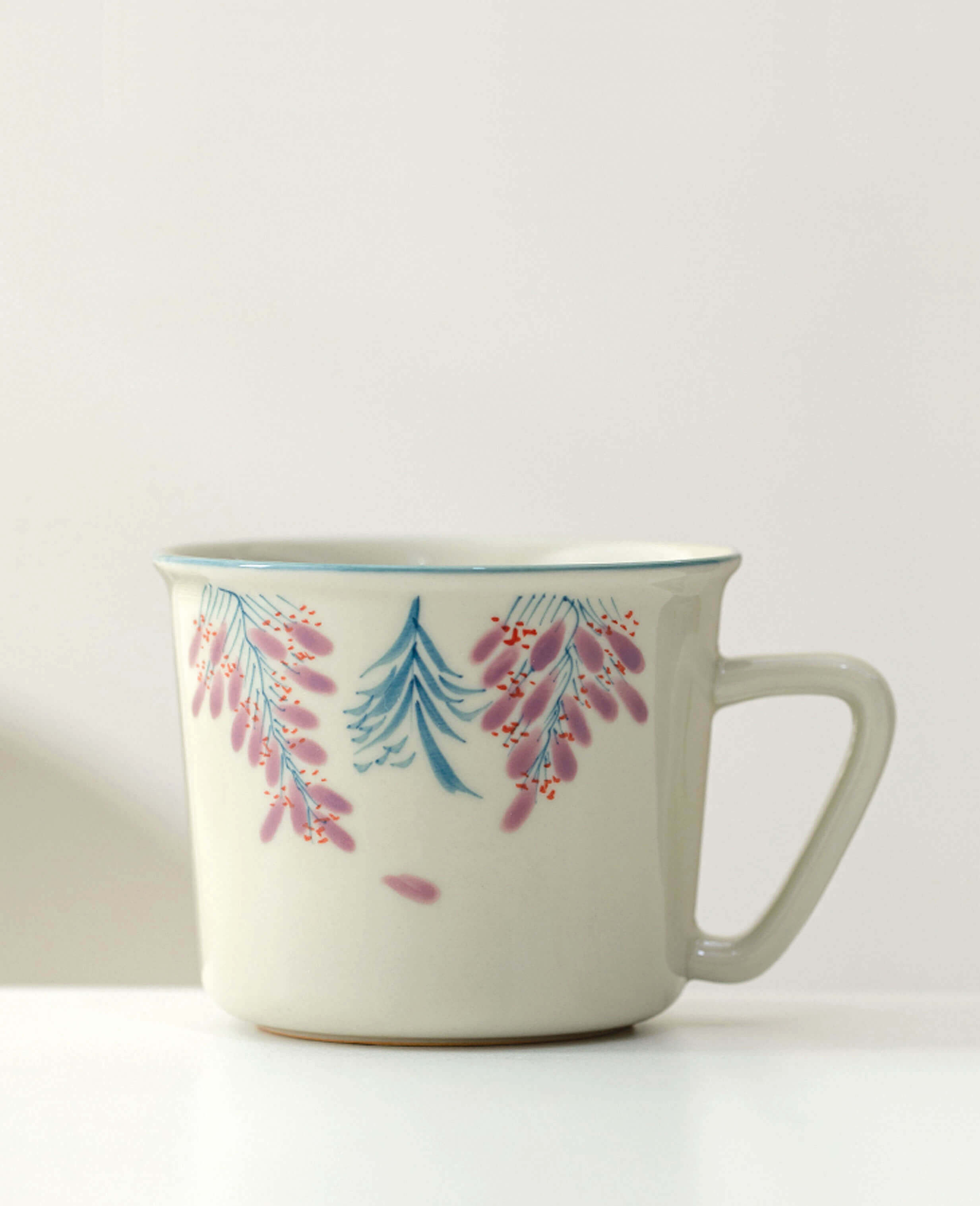 wisteria trace porcelain coffee and tea cup with hand painted floral design front view on white background