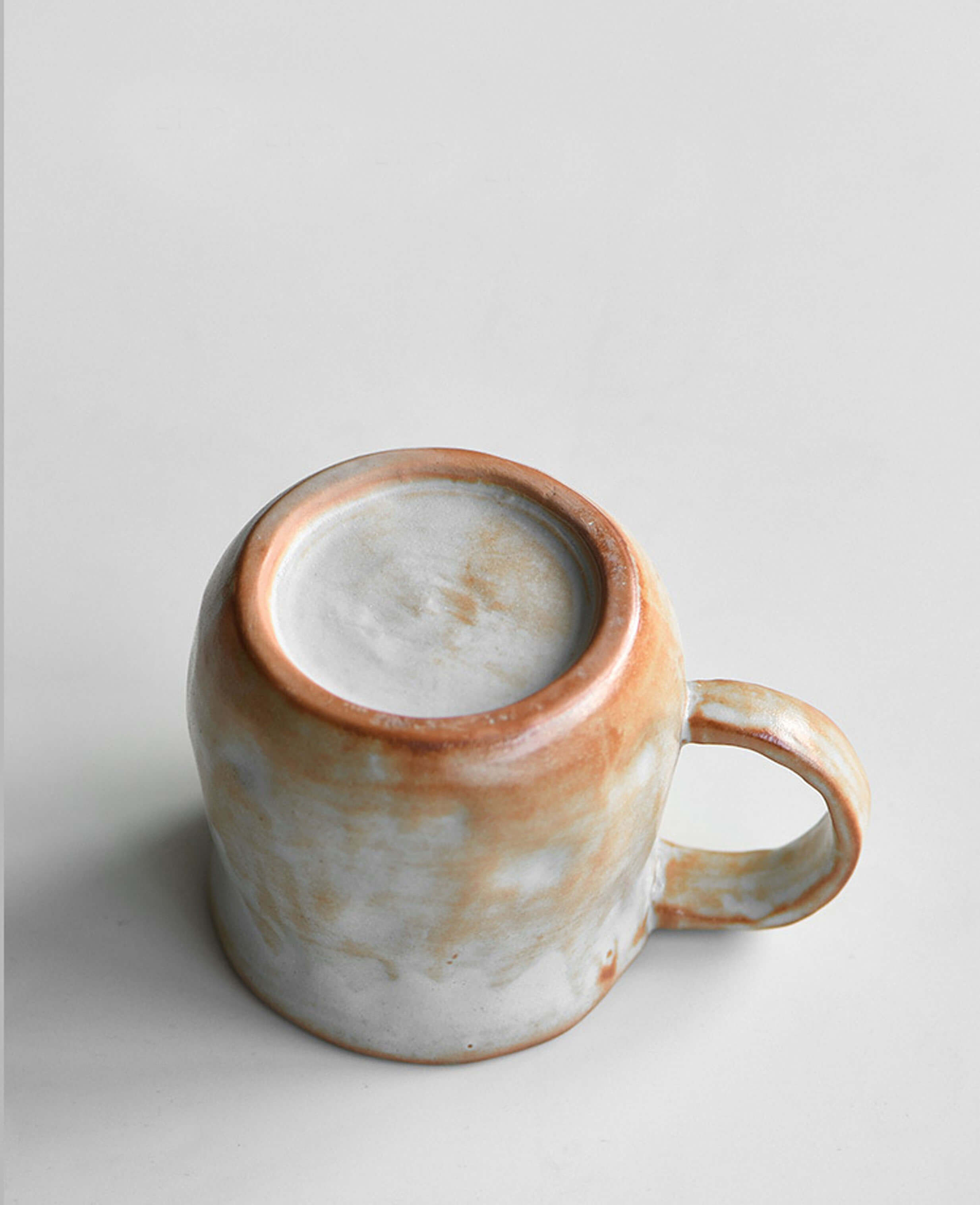 artisan stoneware coffee and tea cup base view snowcrest wood fired flame glaze showing natural variations
