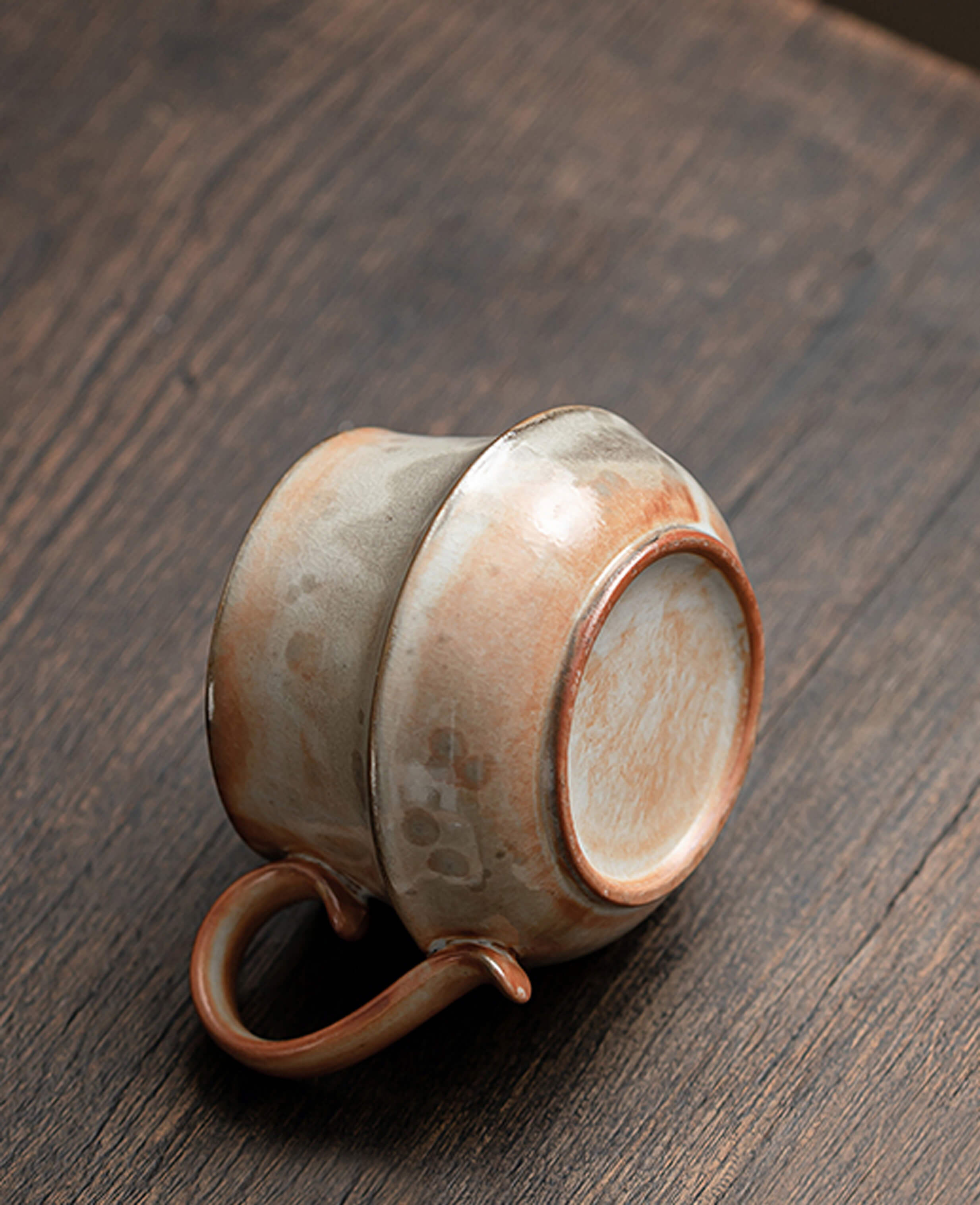 handmade claybourne ceramic coffee and tea cup upside down showing base terracotta handle and rustic stoneware finish