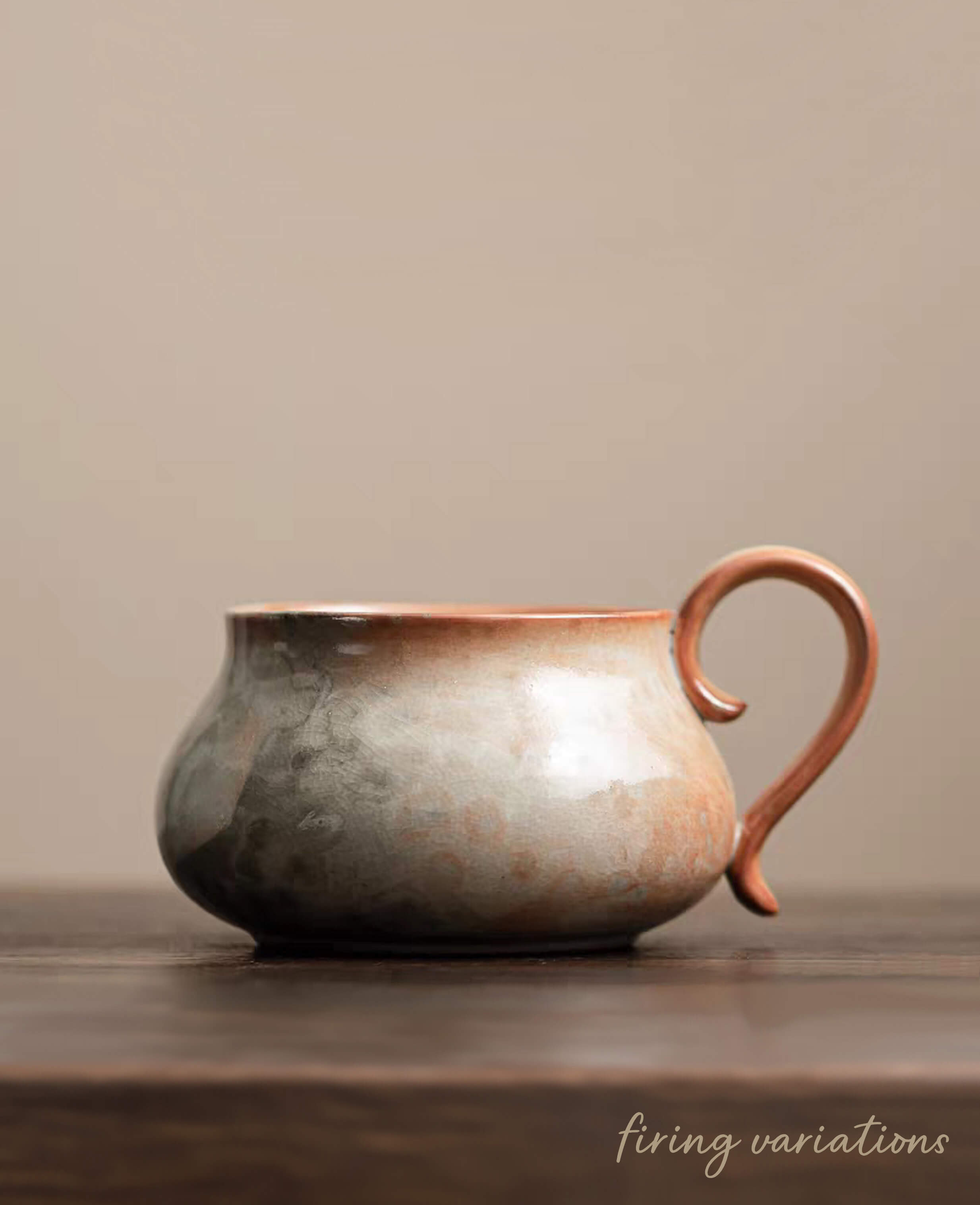 cloudstone handcrafted ceramic mug showing subtle wood firing glaze variations on dark wooden table