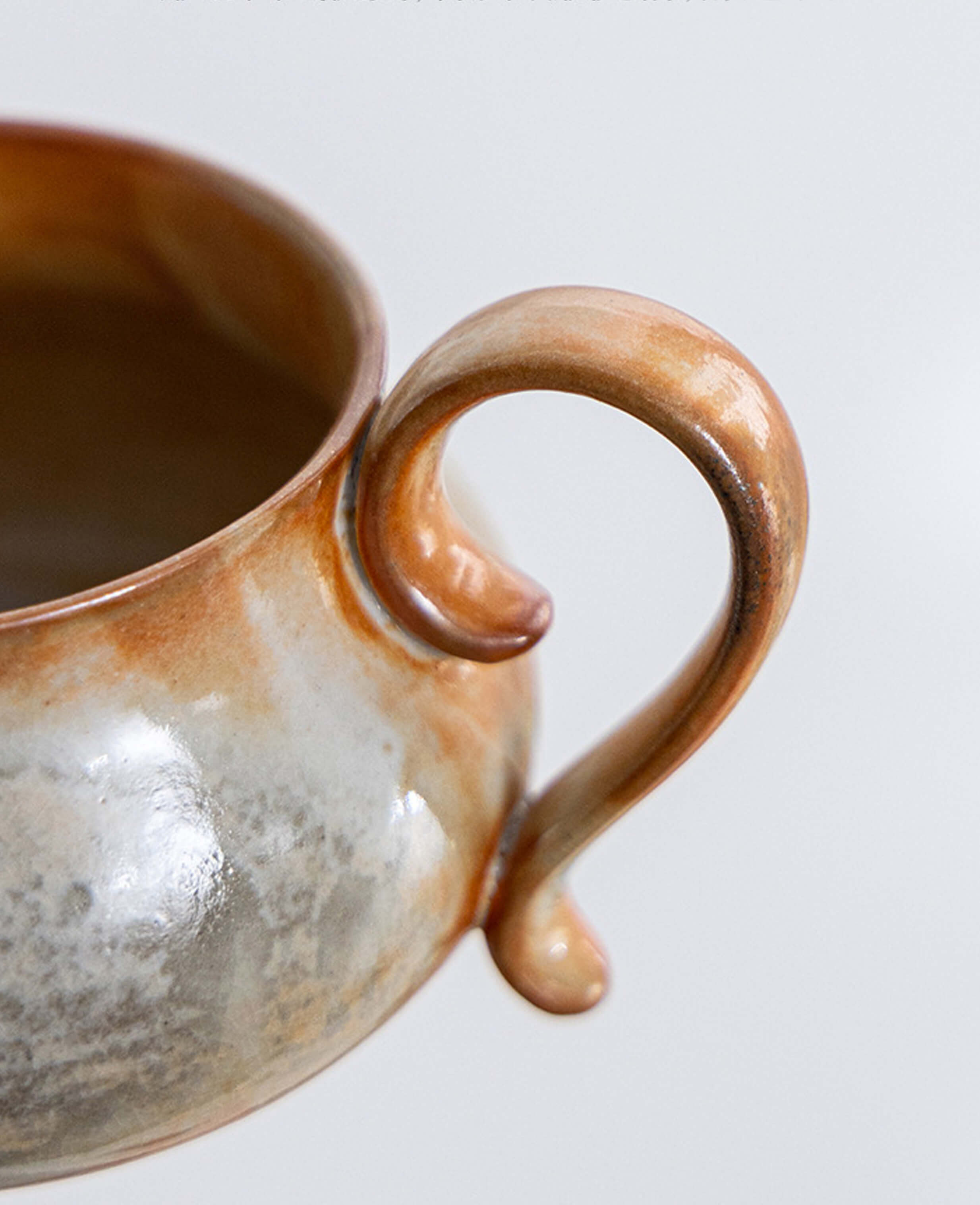 close up of cloudstone ceramic mug handle highlighting artisan craftsmanship and natural glaze finish