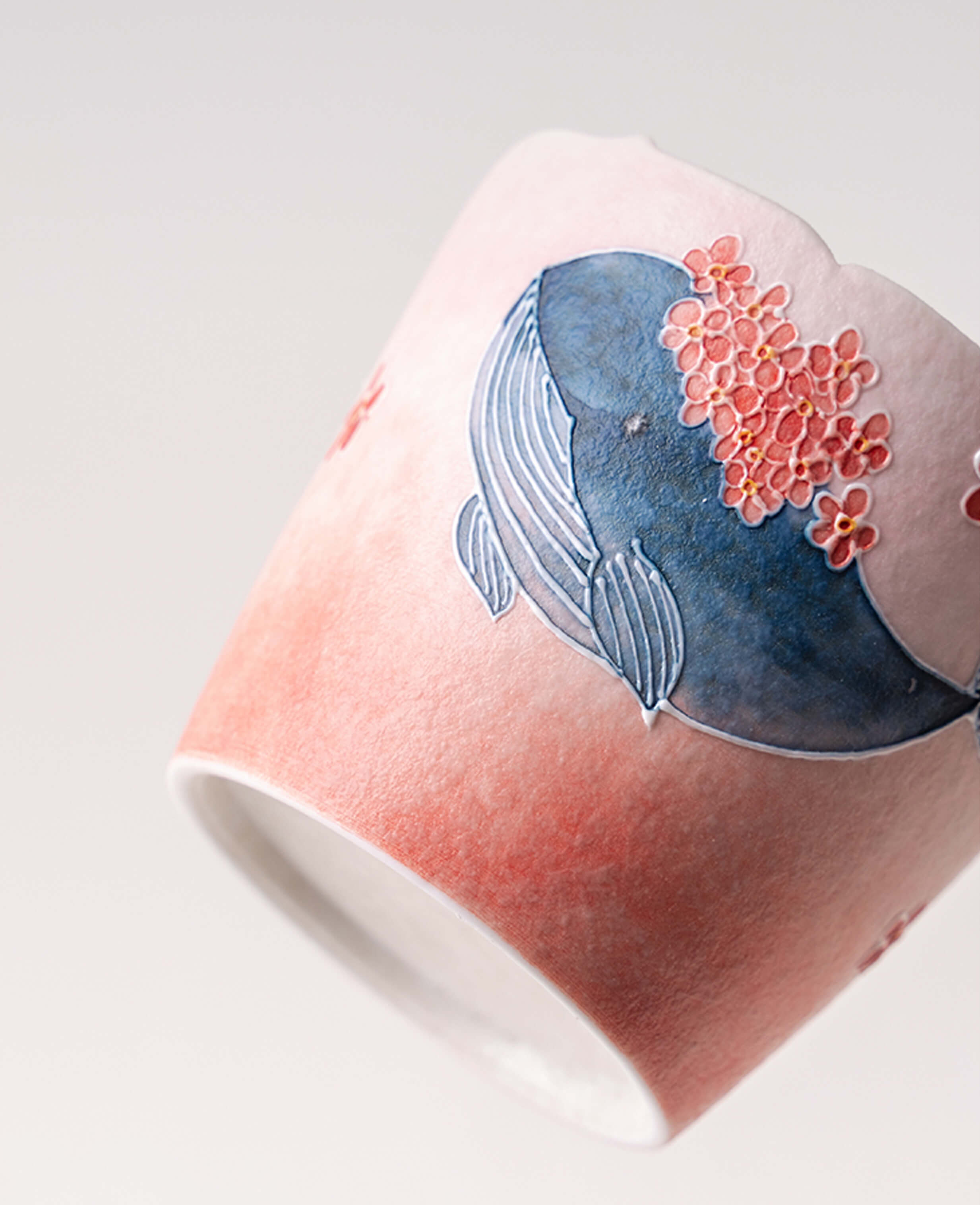 dream tide handcrafted ceramic coffee tea cup with blue whale and coral flower design side view