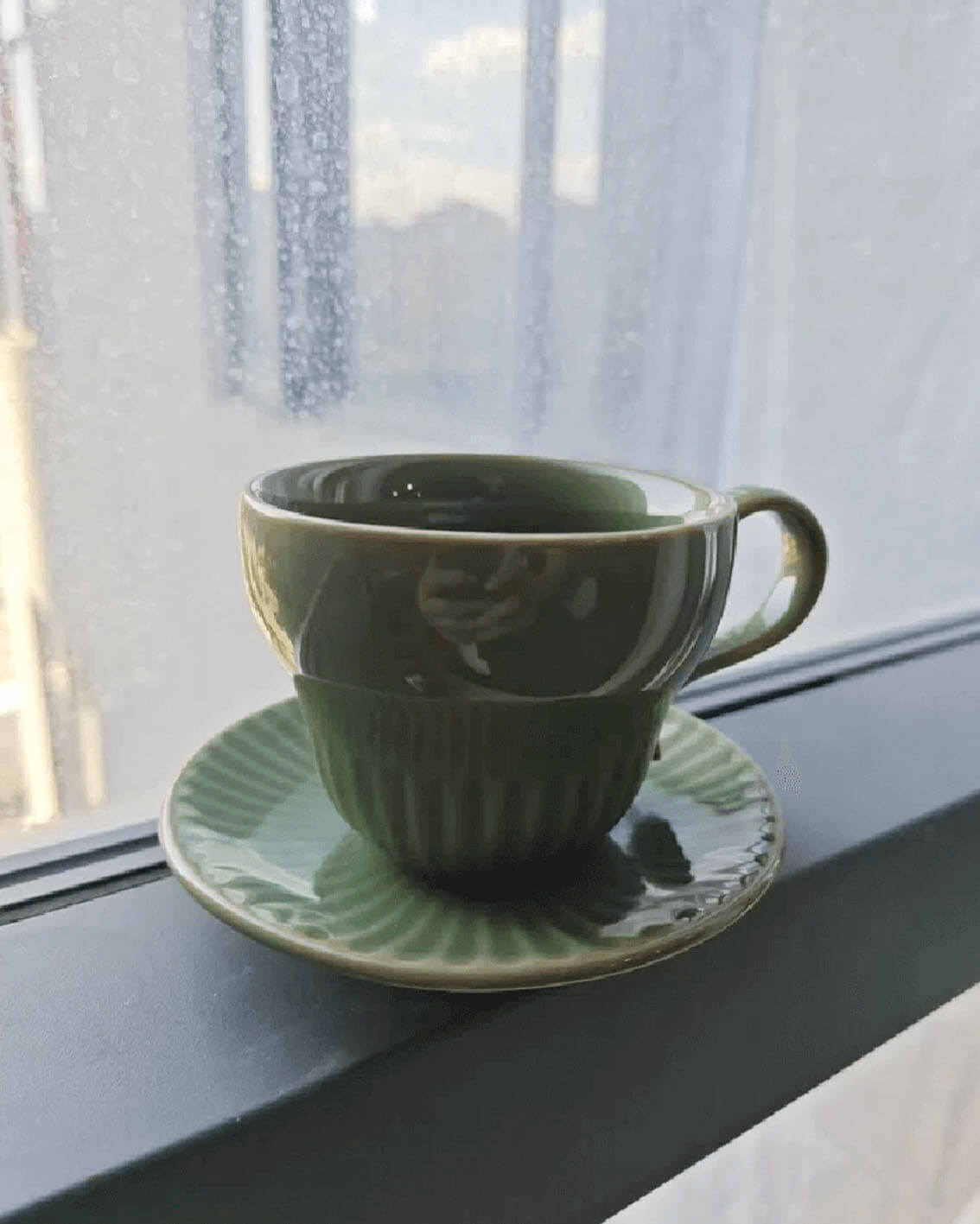 greenstill crest handcrafted porcelain coffee and cup with saucer resting by a window from customer testimonial