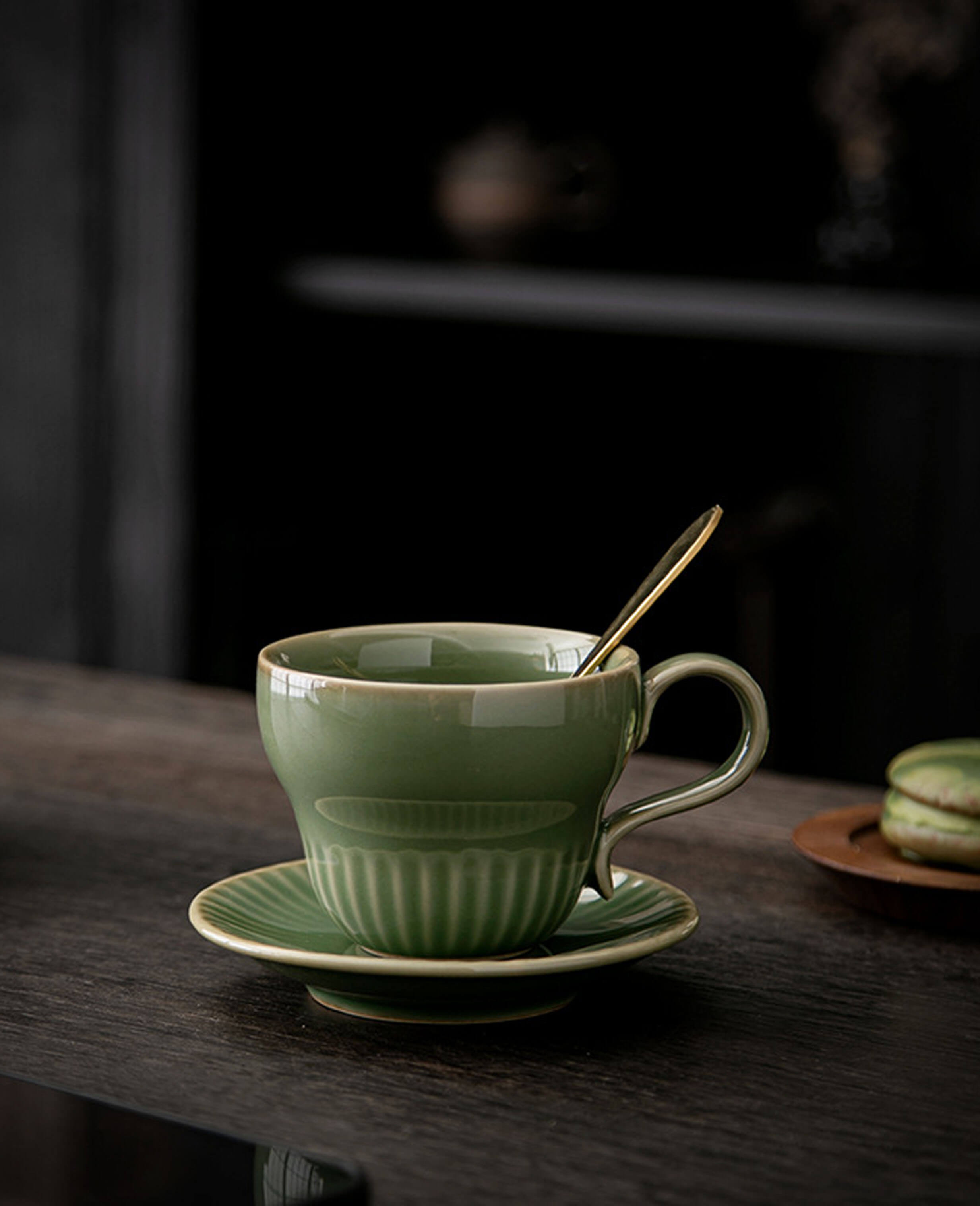 greenstill crest porcelain coffee cup on wooden table in soft morning ambiance