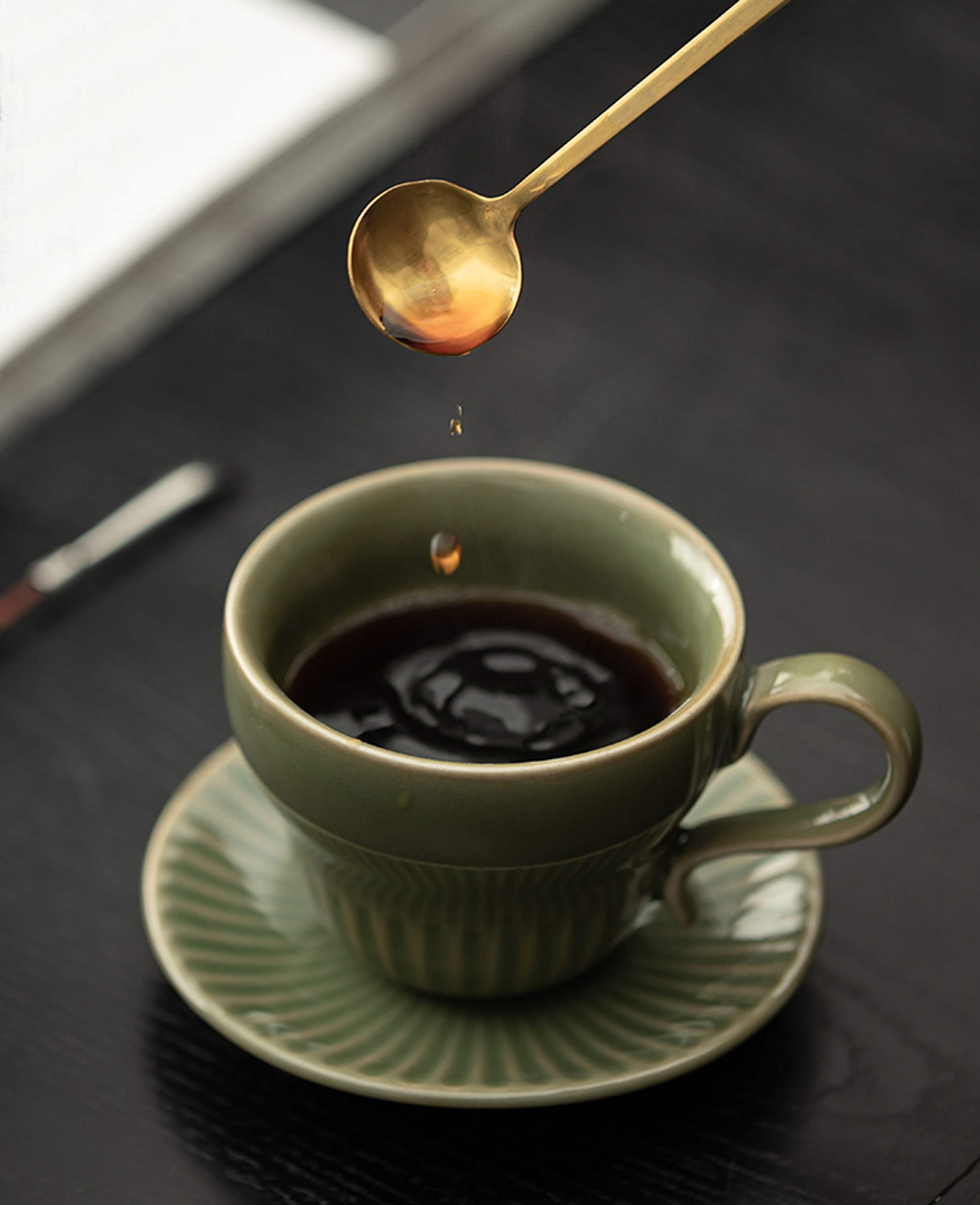 greenstill crest porcelain tea cup being filled with coffee with graceful pouring motion