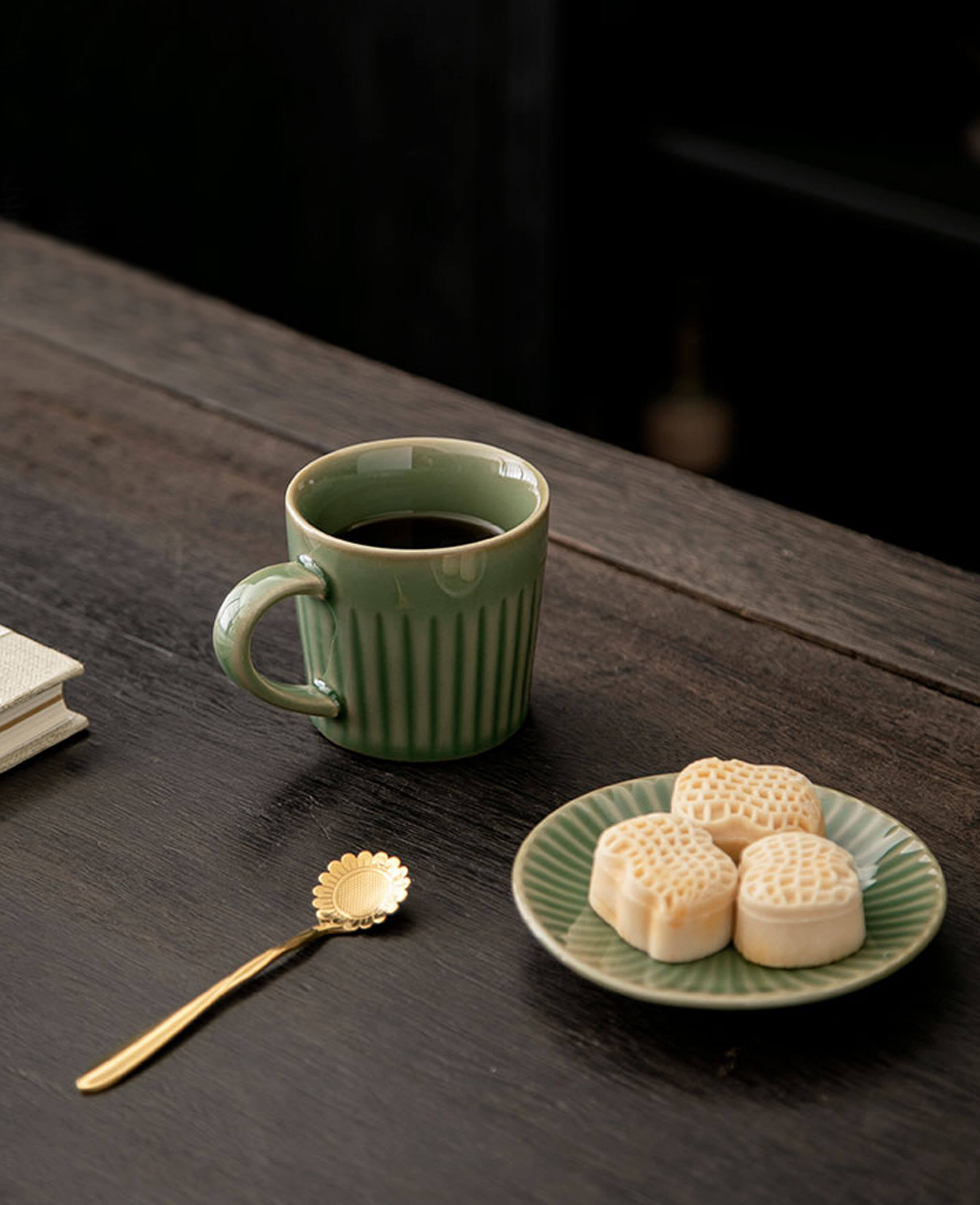 greenstill whisper porcelain coffee mug styled with sweets and a gold floral spoon