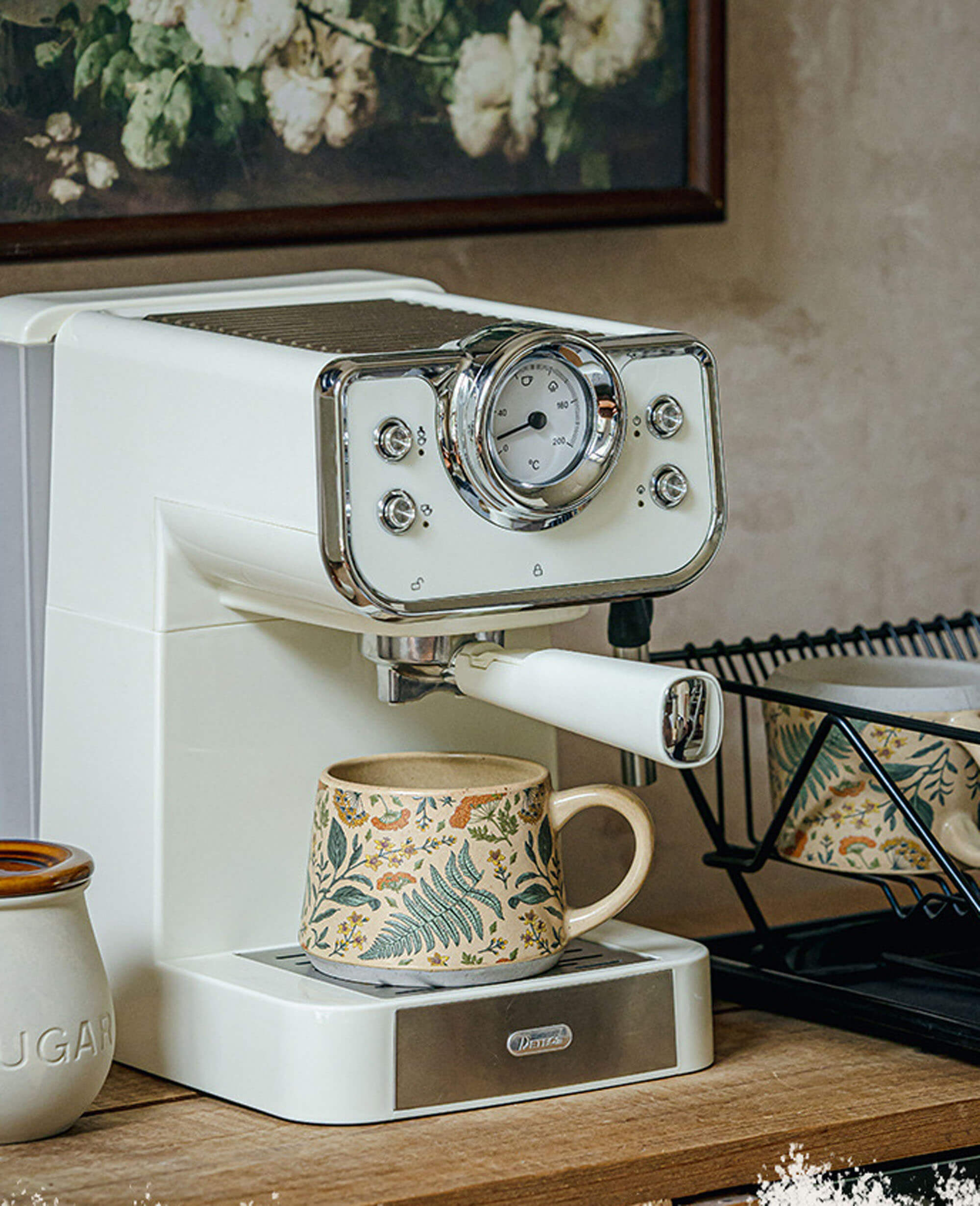 july note ceramic coffee mug under a vintage espresso machine floral pattern visible in a cozy kitchen setting