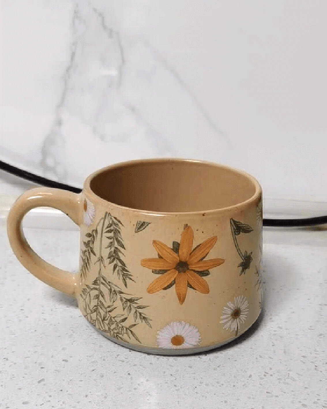 june whisper floral ceramic mug from the summer imprint collection sitting on a light table surface from customer testimonial