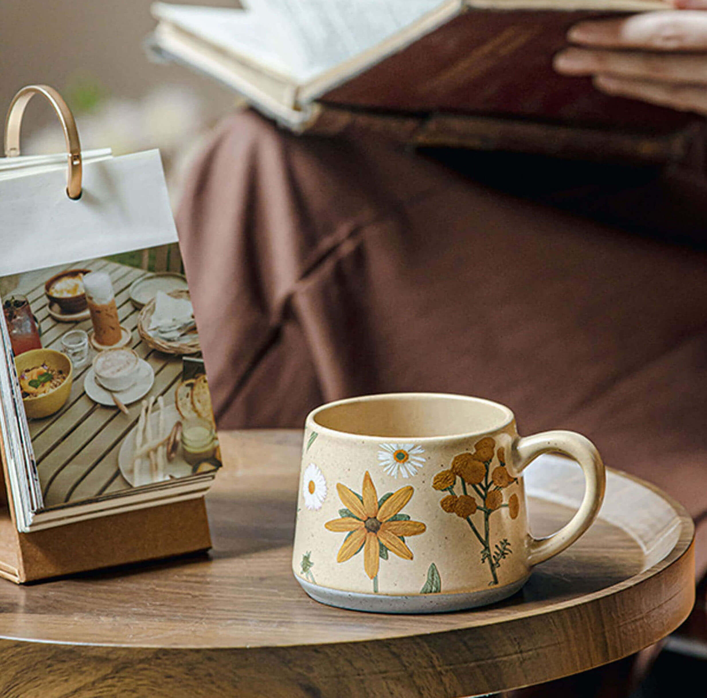 stoneware june whisper floral coffee and tea mug on wooden table beside photo book and open journal from summer imprint collection by ts and cs