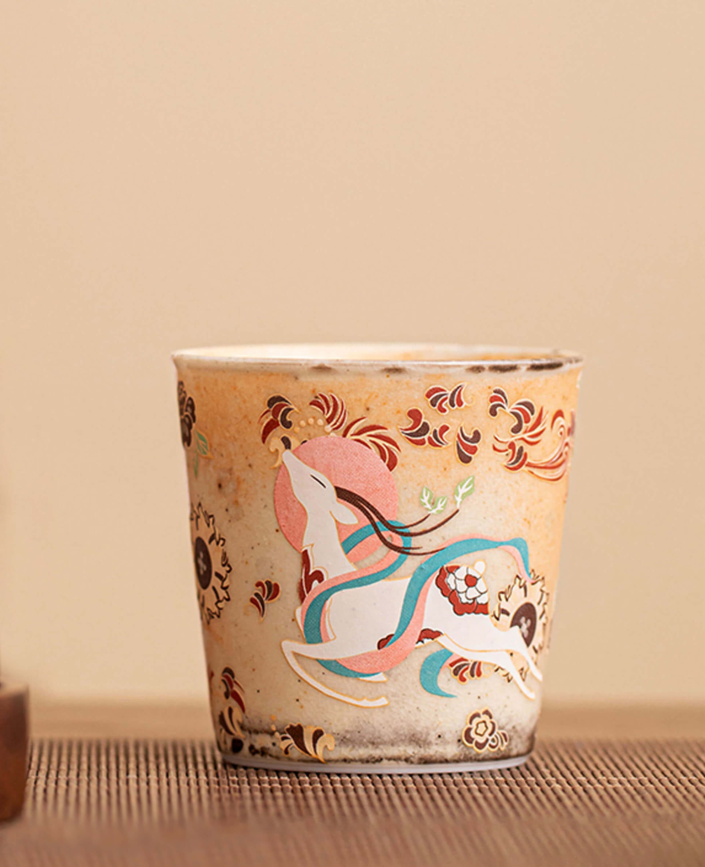 profile view of nine coloured deer aroma cup on table handcrafted ceramic coffee and tea cup with floating deer design ideal for serving espresso