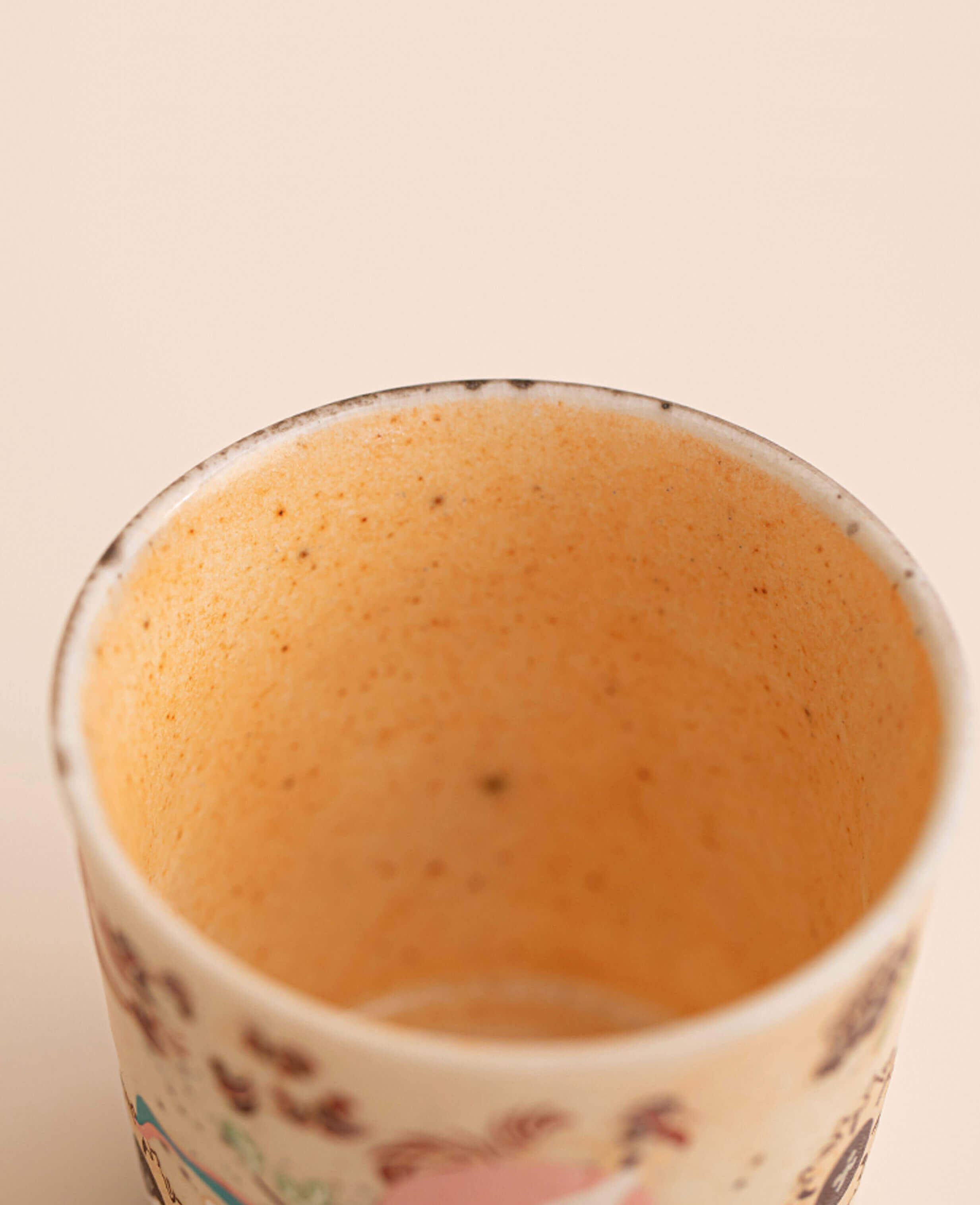 interior detail of nine coloured deer aroma cup view of smooth glazed interior of a ceramic espresso and tea cup with a warm toned finish