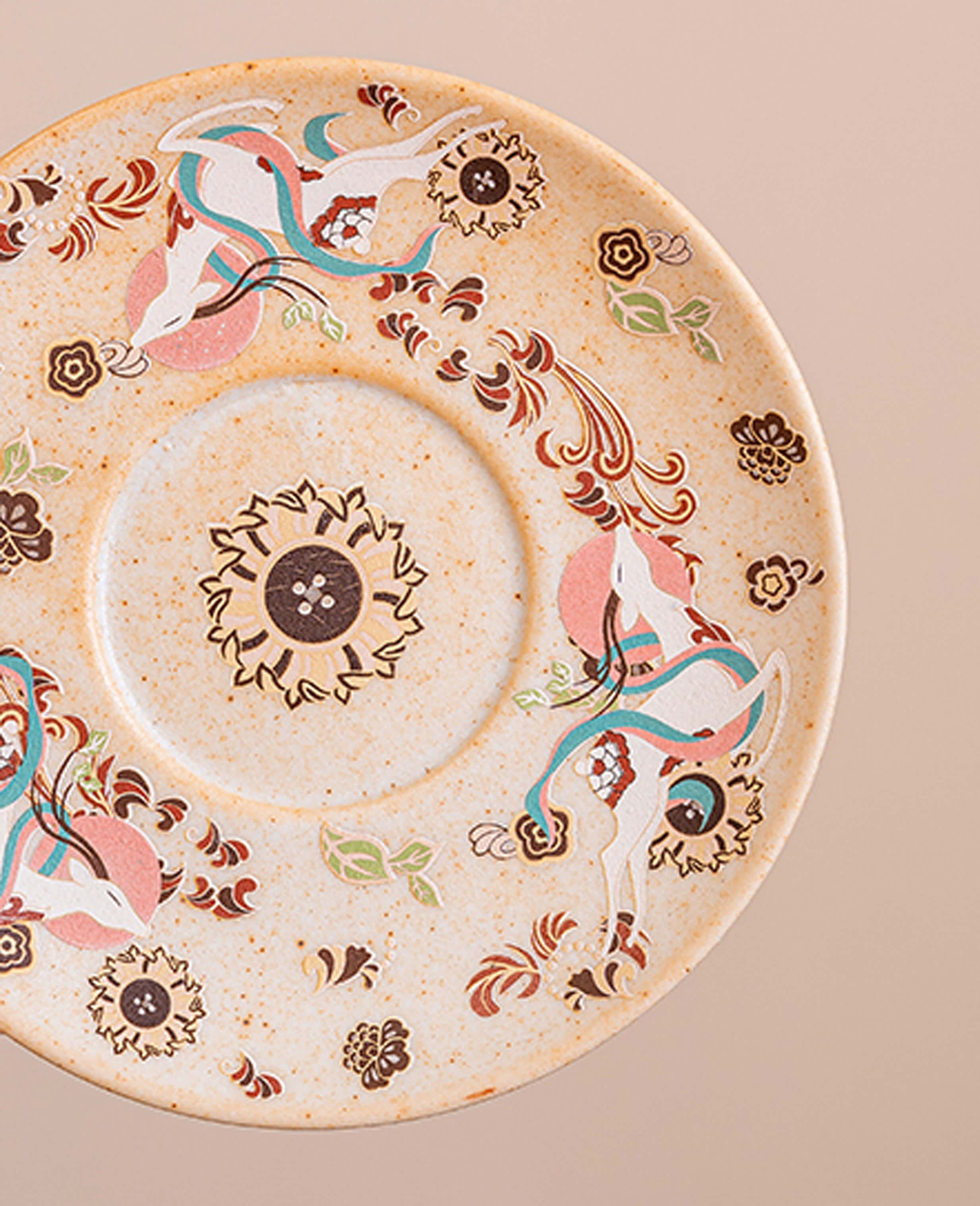 top view of nine coloured deer ceramic saucer featuring painted deer and floral design