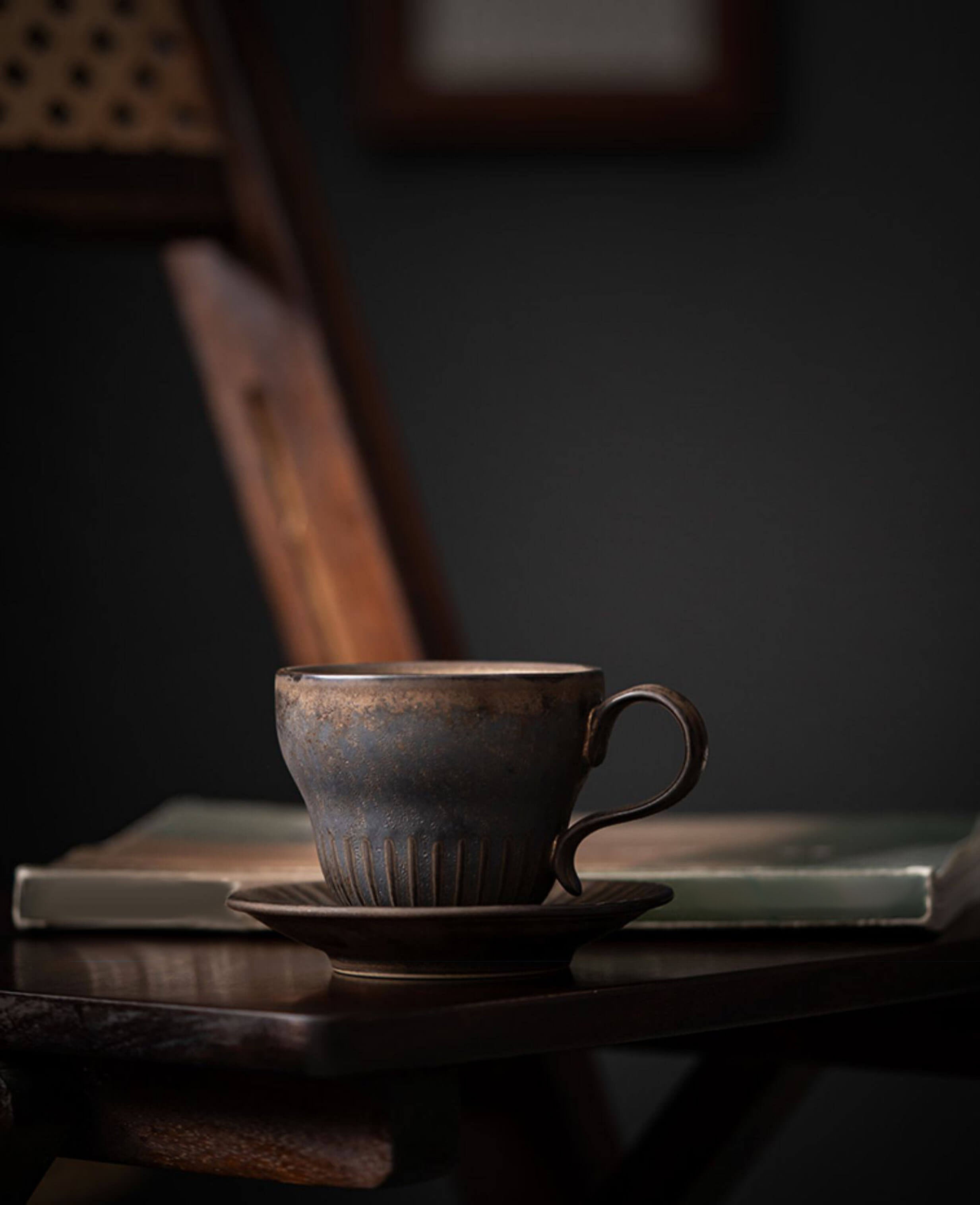 rustglow crest ceramic coffee cup placed beside stacked books