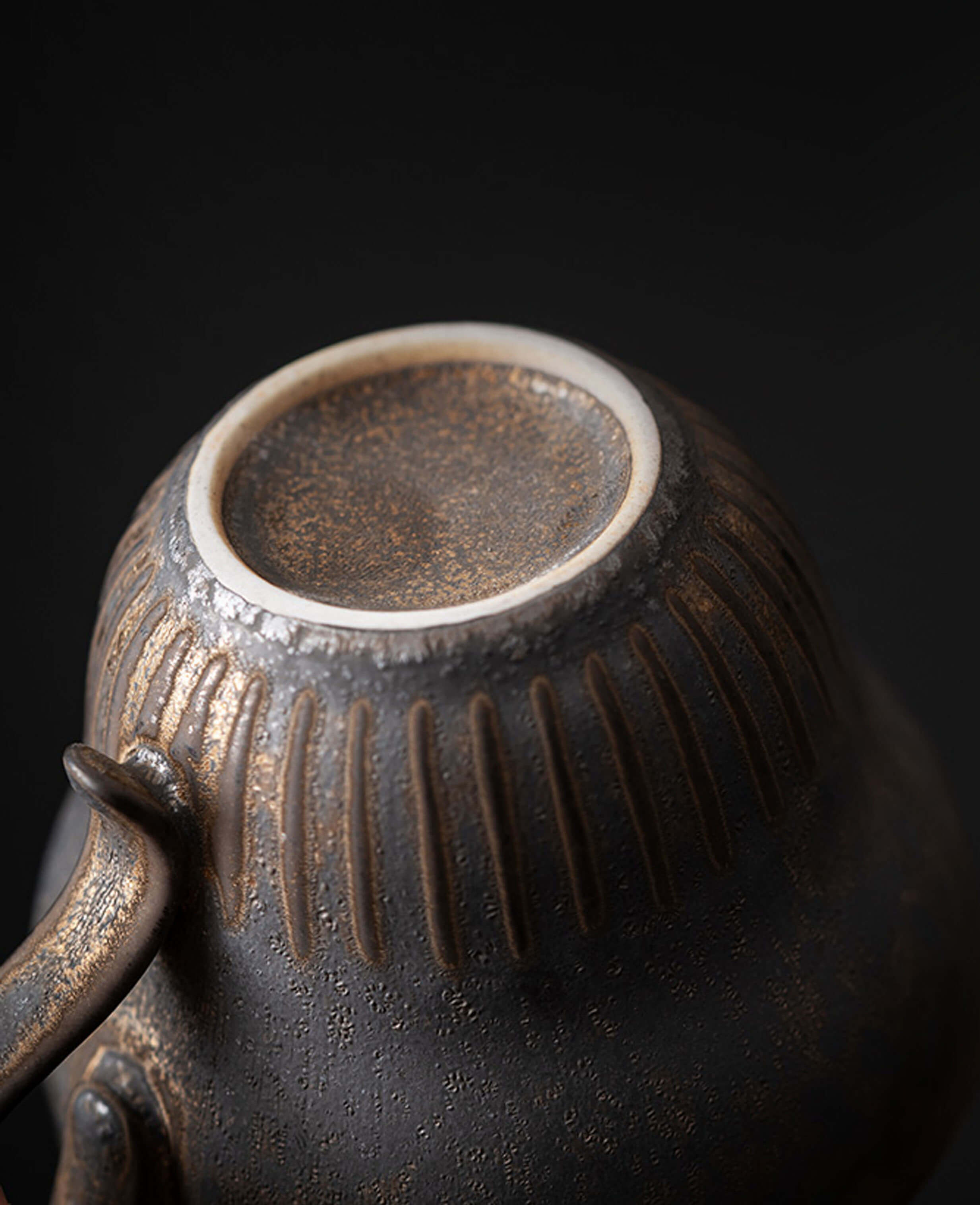 rustglow crest textured ceramic coffee cup bottom closeup