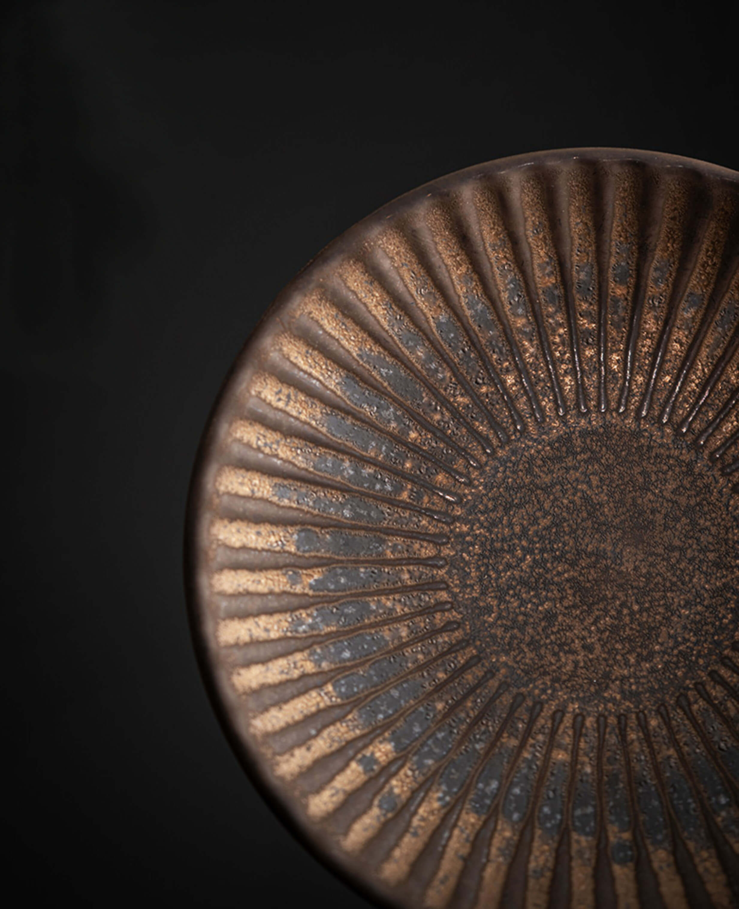 top view of rustglow strata rustic ceramic coffee saucer with a golden brown ridged glaze finish
