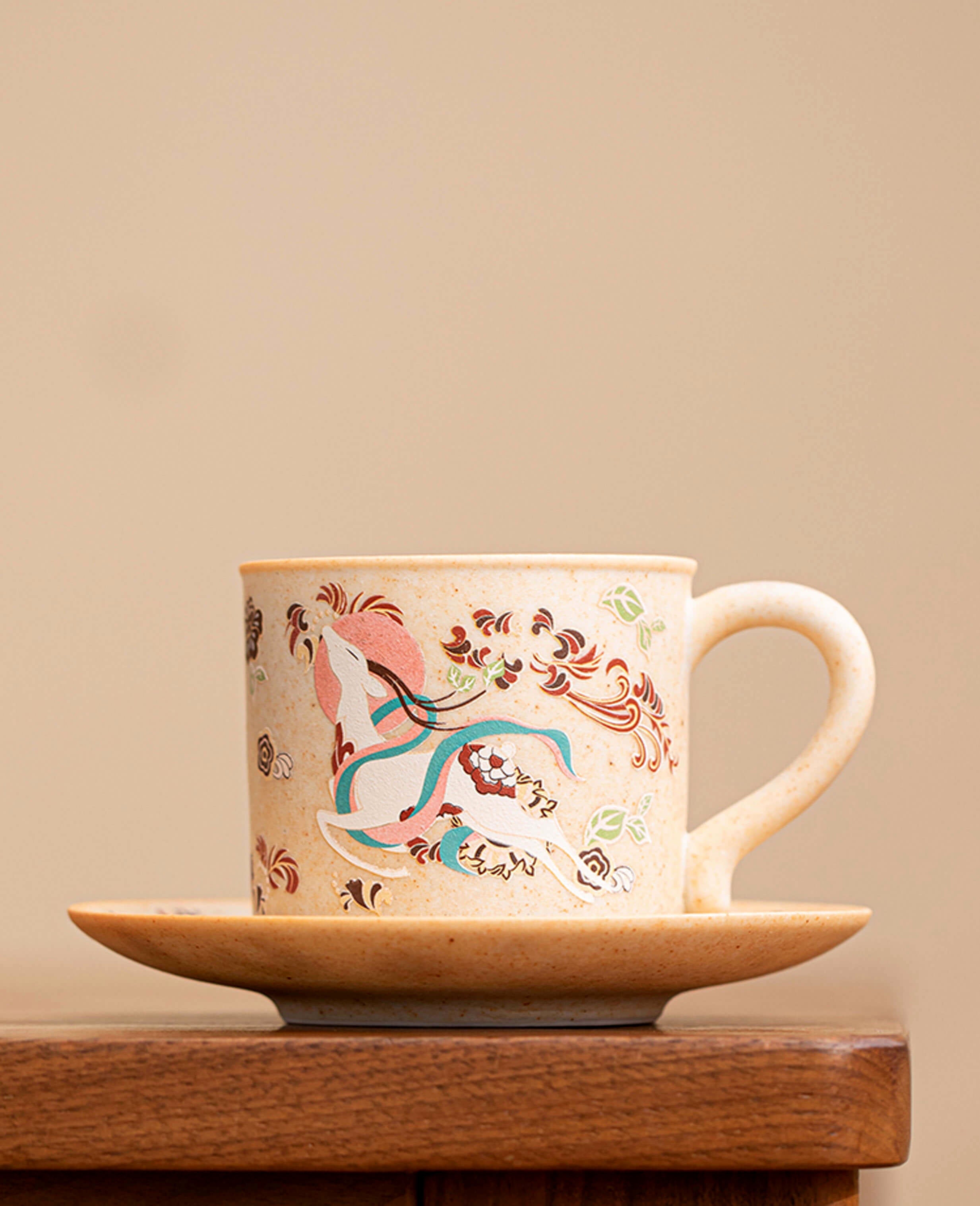 side view of nine coloured deer ceramic coffee mug and saucer showcasing dunhuang style pattern