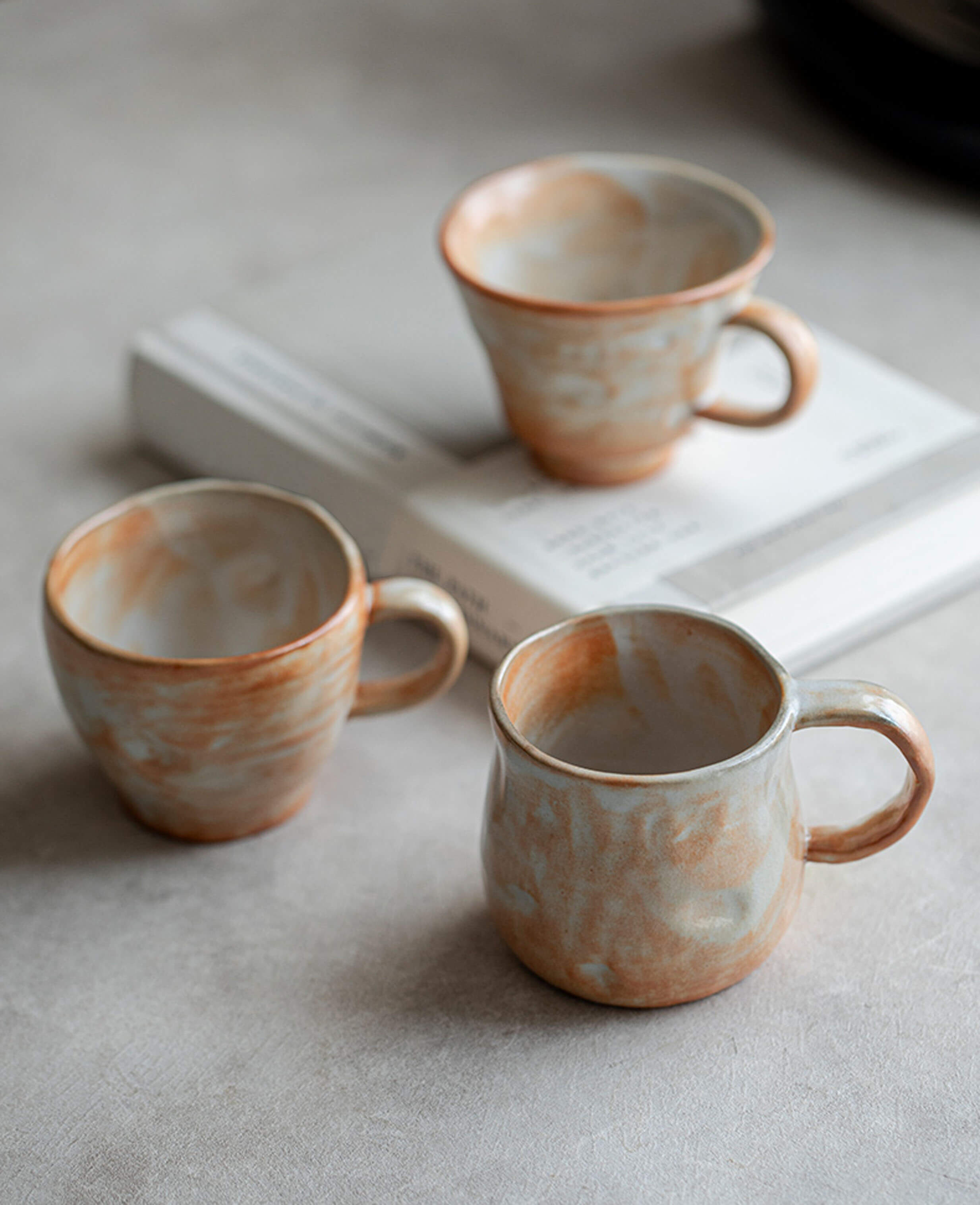 handcrafted stoneware coffee and tea cups trio snowcrest wood fired flame glaze with warm earthy tones