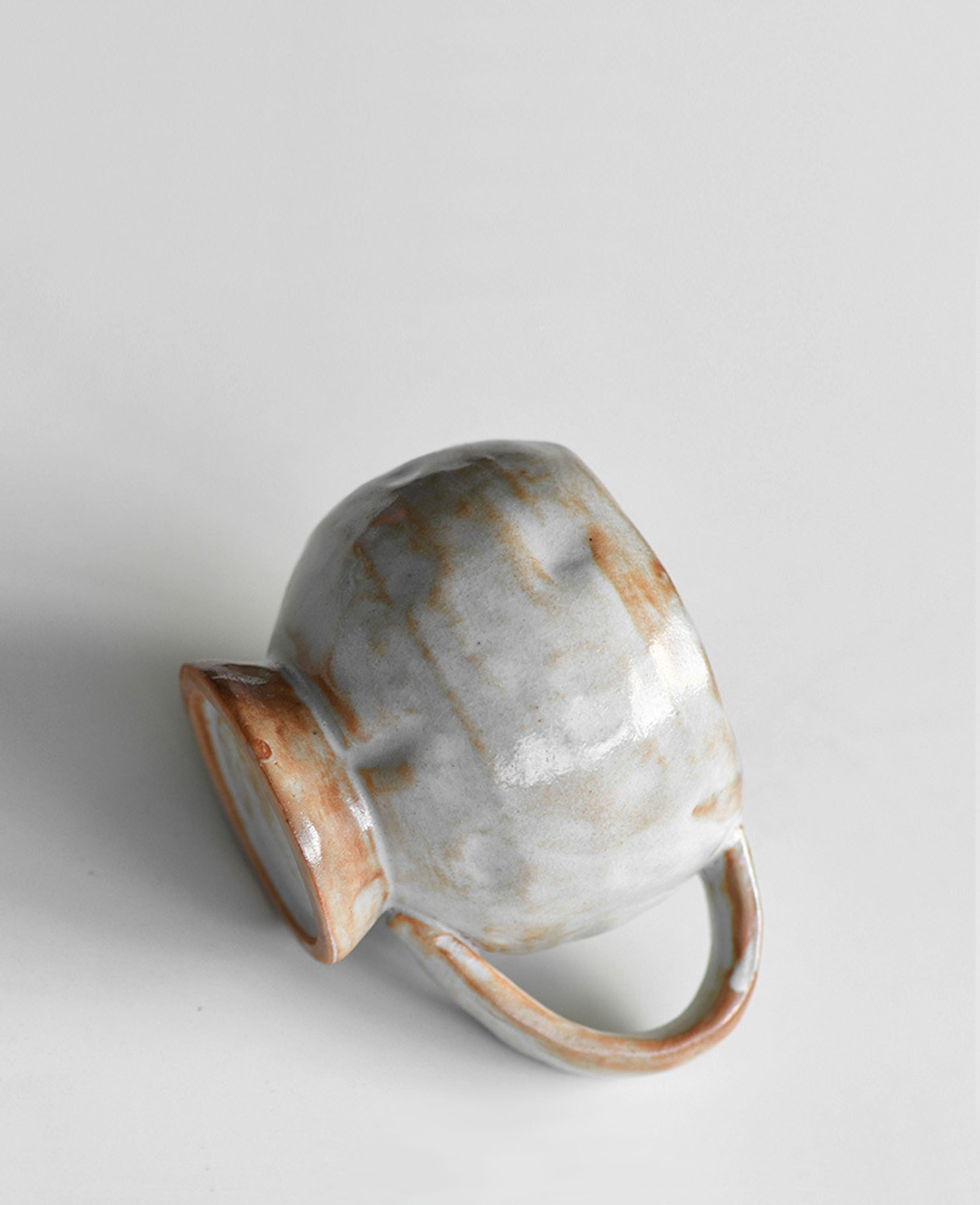 solterra handmade ceramic coffee and tea cup showing natural clay texture with side and base view