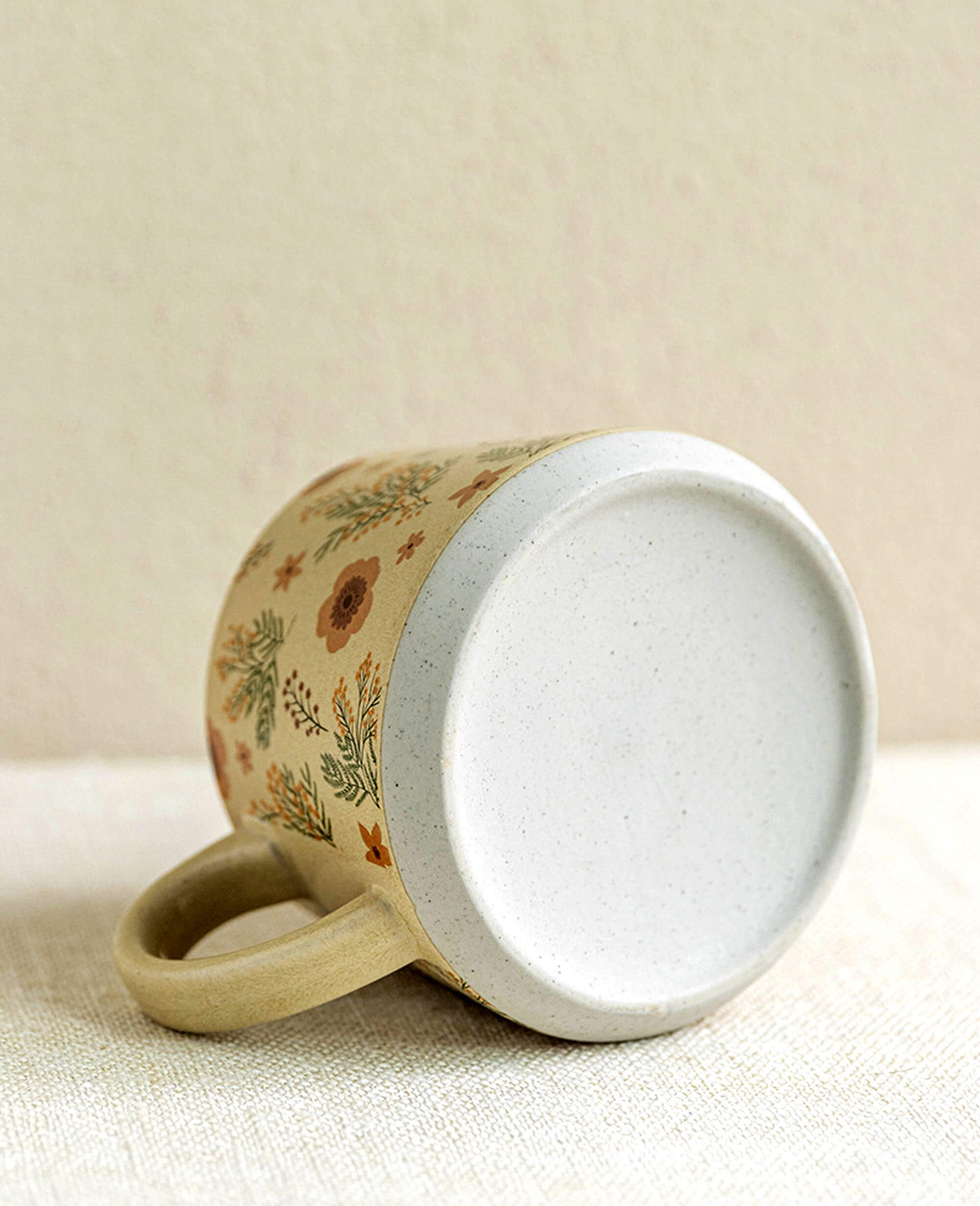 bottom of rustic stoneware coffee and tea mug showing matte unglazed base minimalist natural look