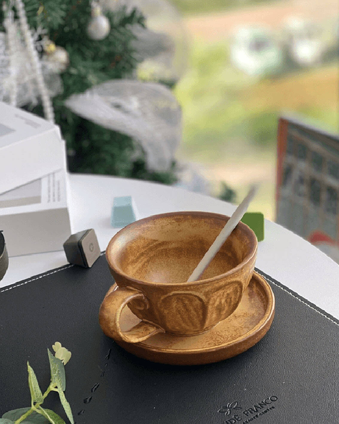 toffee reverie bellara handcrafted stoneware coffee cup and saucer on an outdoor balcony scene from customer testimonial