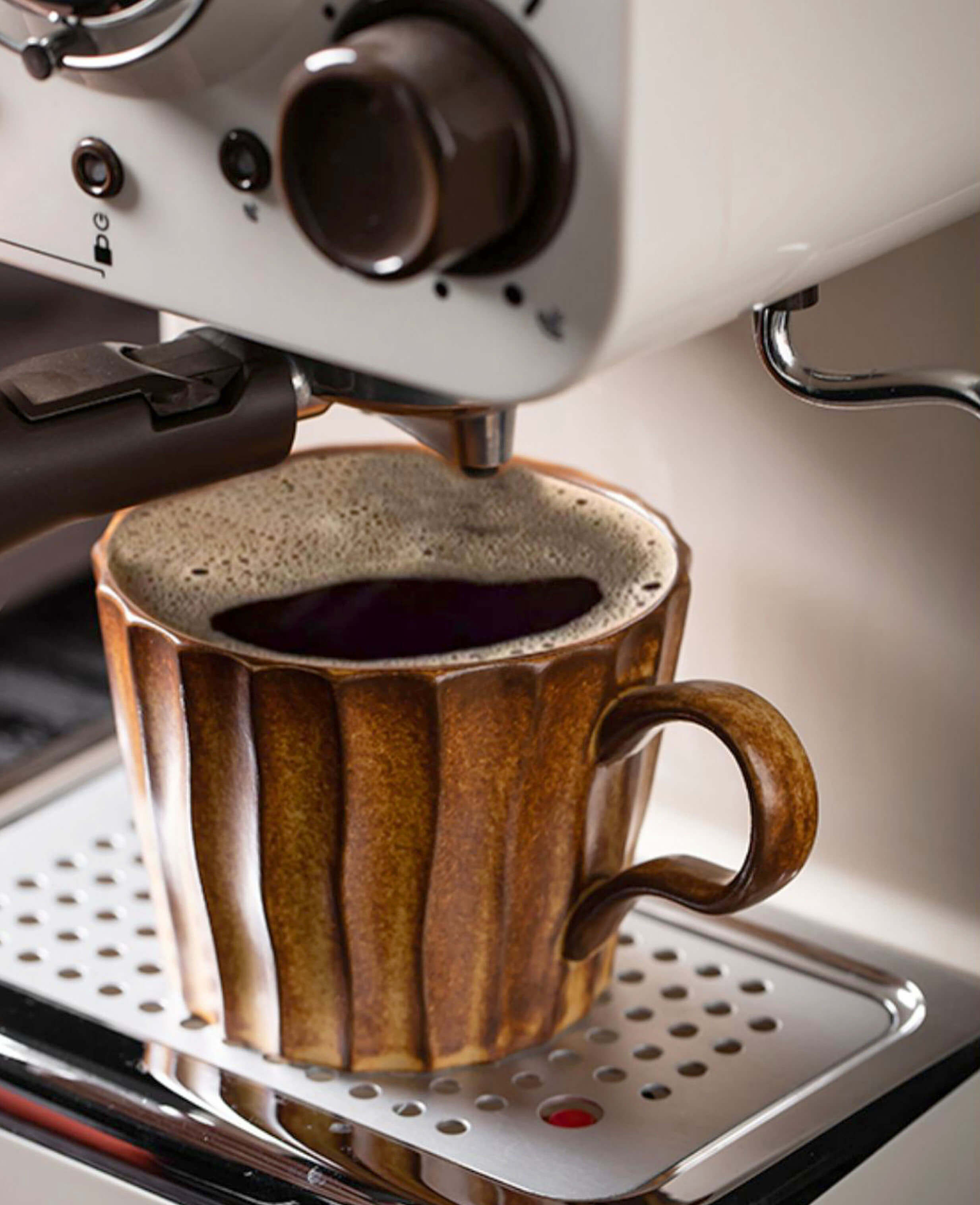 toffee reverie flow coffee cup brewing under espresso machine spout