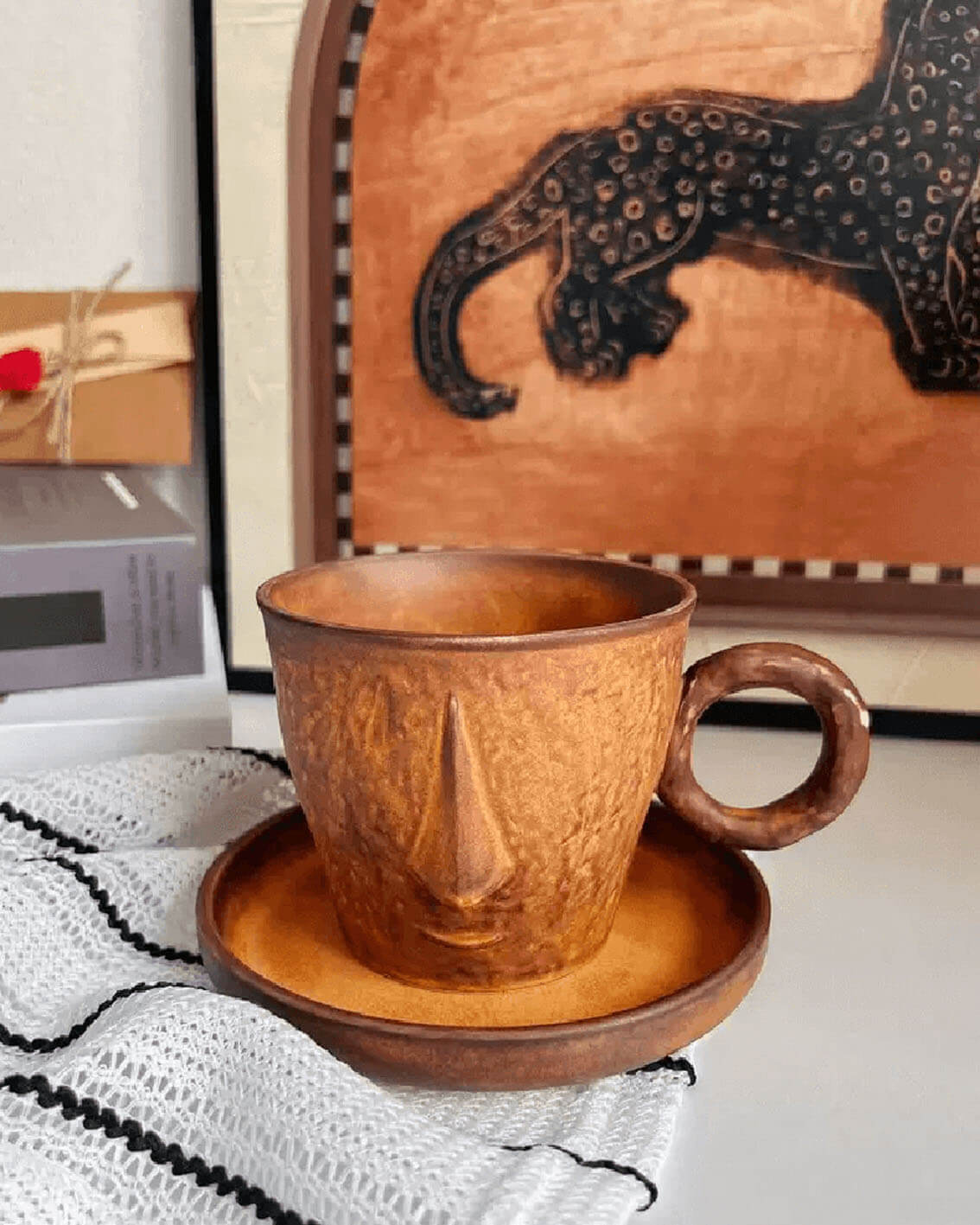 toffee reverie muse handcrafted sculptural stoneware coffee mug placed on woven white cloth from customer review