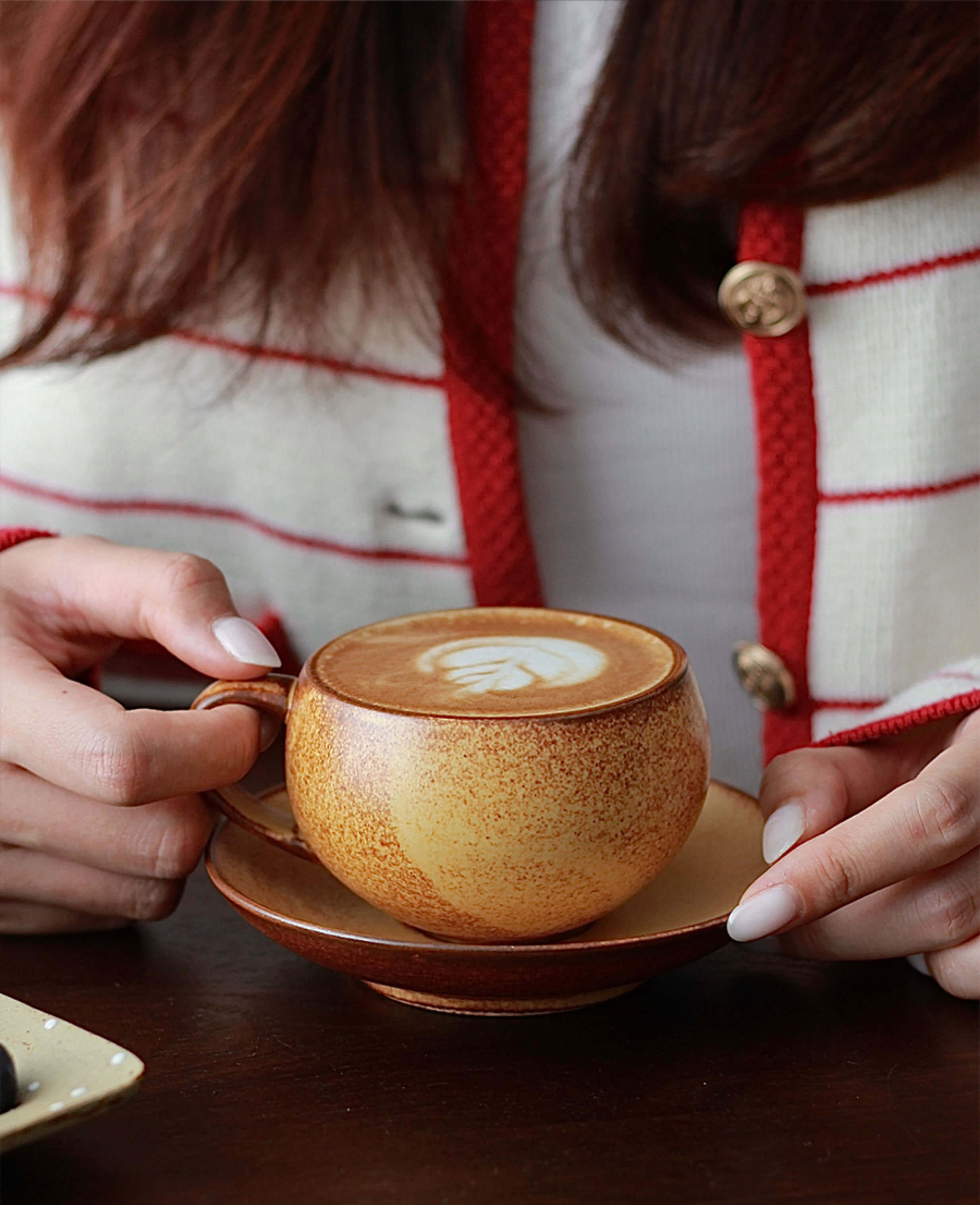 toffee reverie ovolo coffee cup held in hand showing size and rounded form